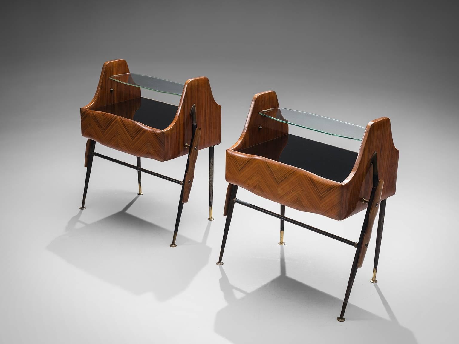 Nightstands, wood, metal, glass and brass, Italy, 1950s.

These two side tables or nightstands are both refined and elegant in every way. The glass top hangs in between the main body that has a rosewood inlayed pattern. The main body of the cabinet