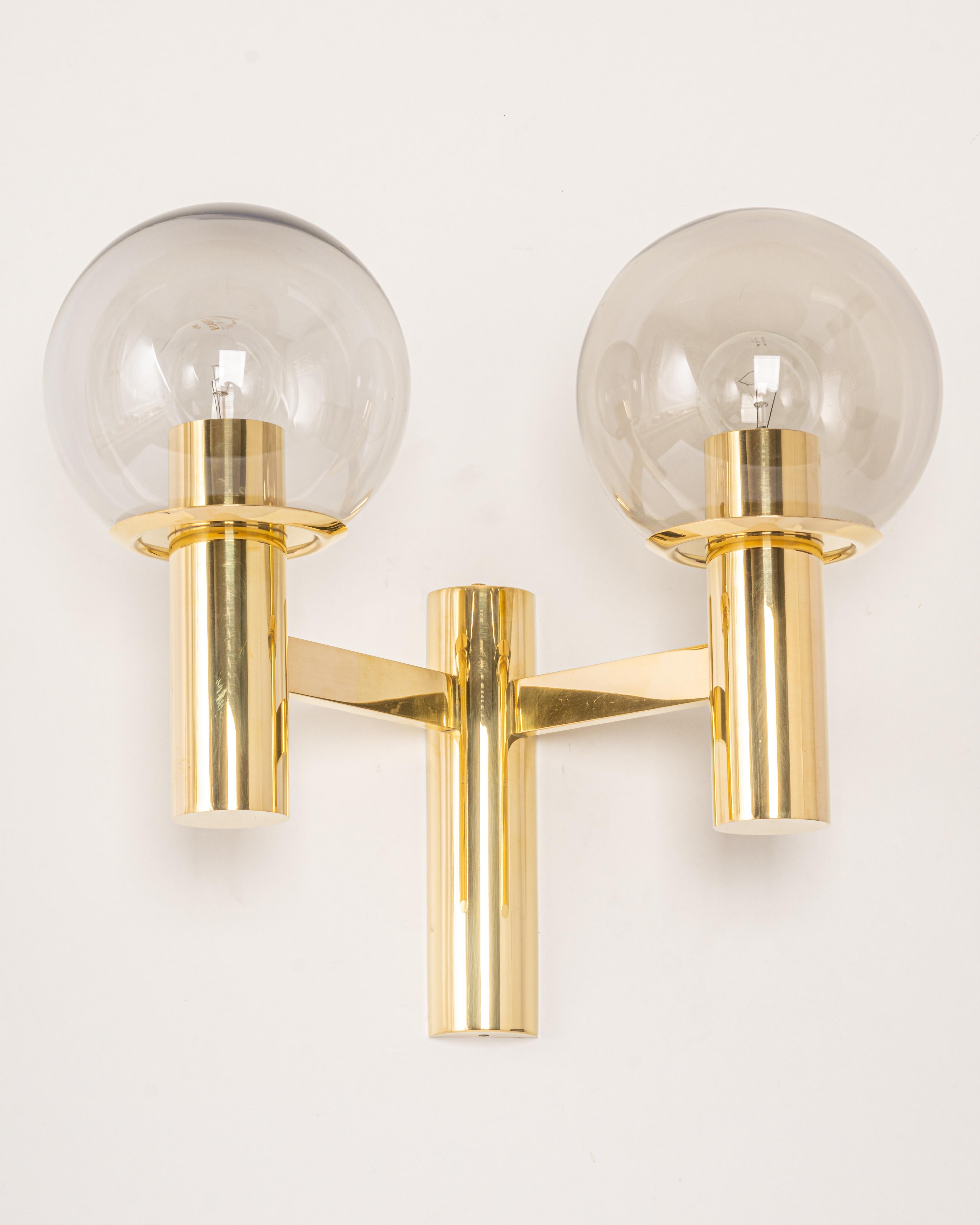 Pair of wall sconces in the manner of Sciolari, Made in Germany, 1970s.
Each sconce is composed of 2 smoked glasses with a brass base.

High quality and in very good condition. Cleaned, well-wired, and ready to use. 
Each sconce requires 2 x E27