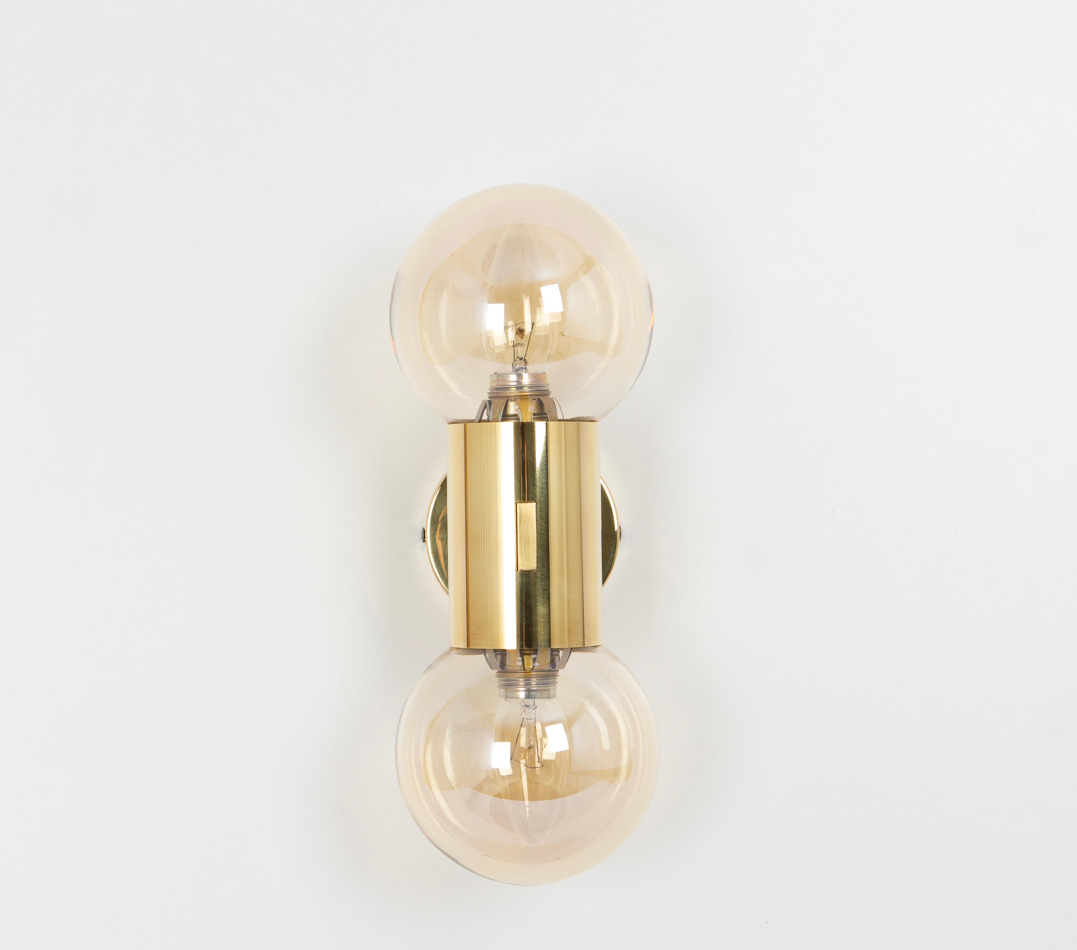 Pair of wall sconces in the manner of Sciolari, Made in Germany, 1970s.
Each sconce is composed of 2 smoked glasses with a brass base.

High quality and in very good condition. Cleaned, well-wired, and ready to use. 
Each sconce requires 2 x E14
