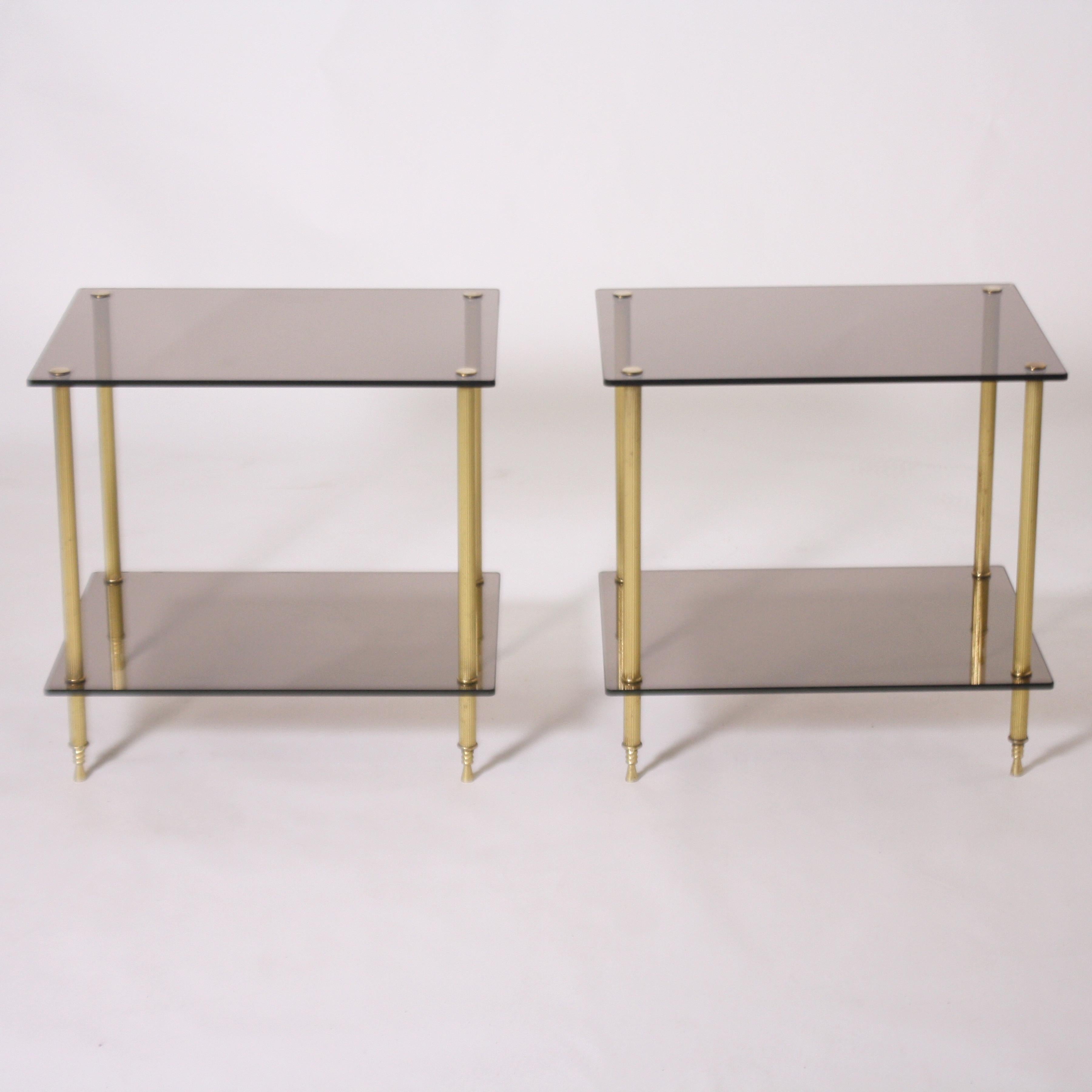 Pair of brass and smoked glass tables, circa 1950.