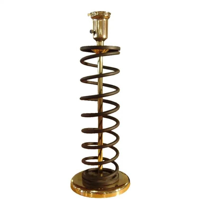 Pair of brass and steel coil spring lamps in the Manner of Donald Deskey

A pair of lamps in the form of large springs similar in style to designs by Donald Deskey. The base, center column, and socket cover are brass. The spring form in black