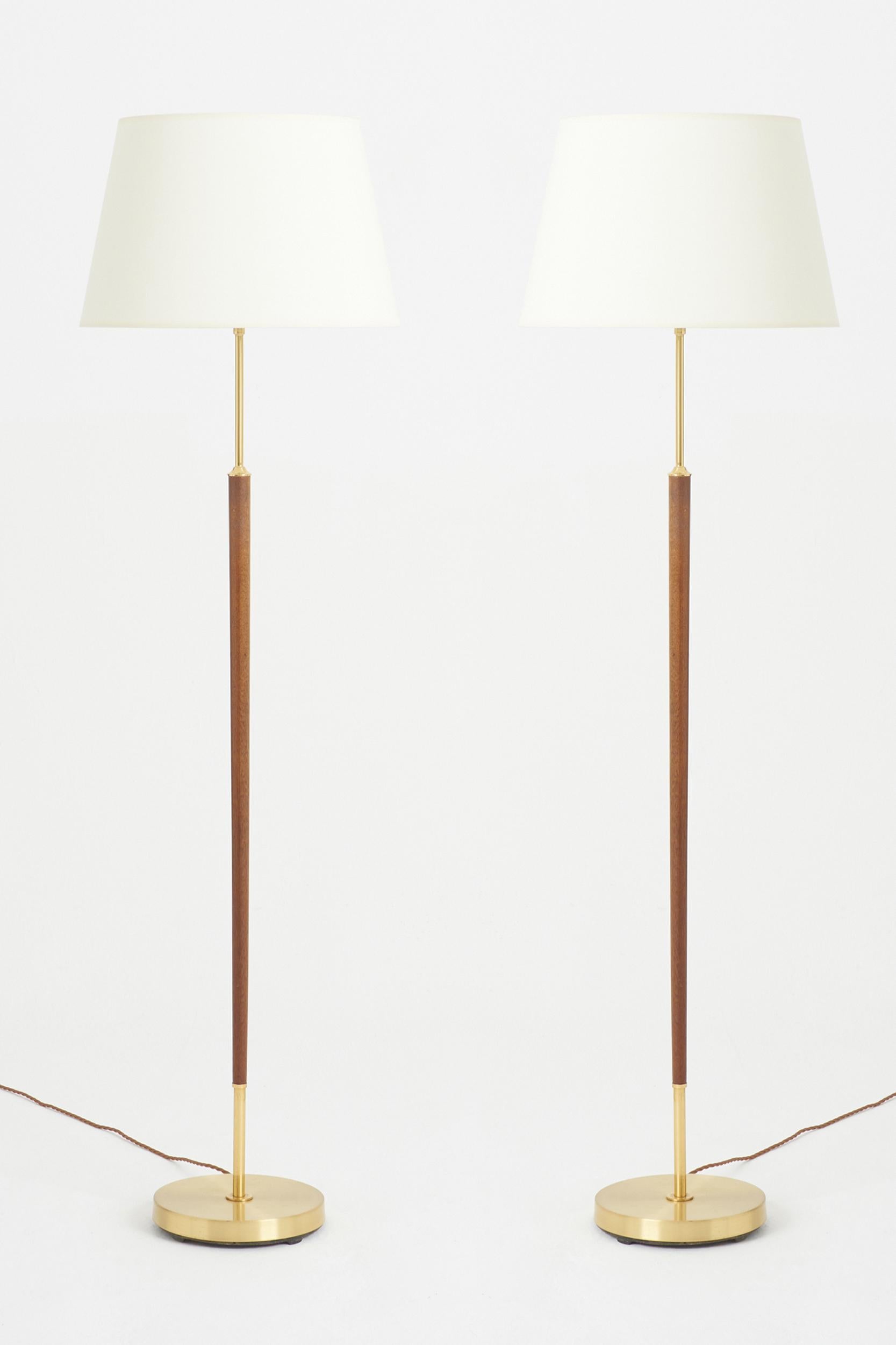 A pair of brass and walnut floor lamps.
Sweden, 1970s.
With the shade: 145 cm high by 41 cm diameter
Lamp base only: 126 cm high by 23 cm diameter