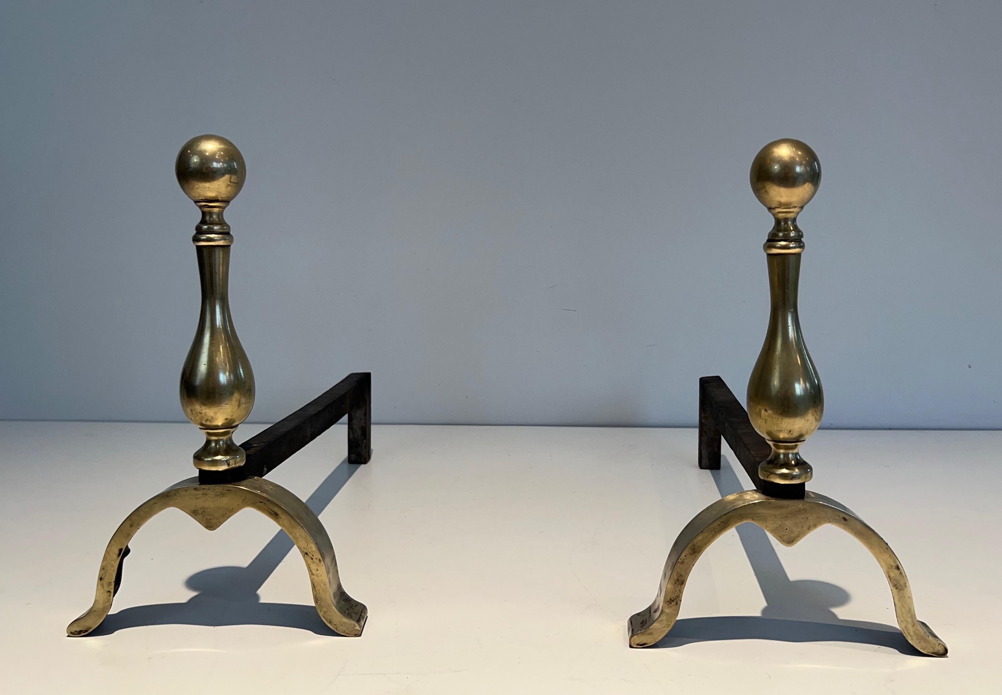 This pair of neoclassical style andirons is made of bronze. This is a French work. Circa 1920.