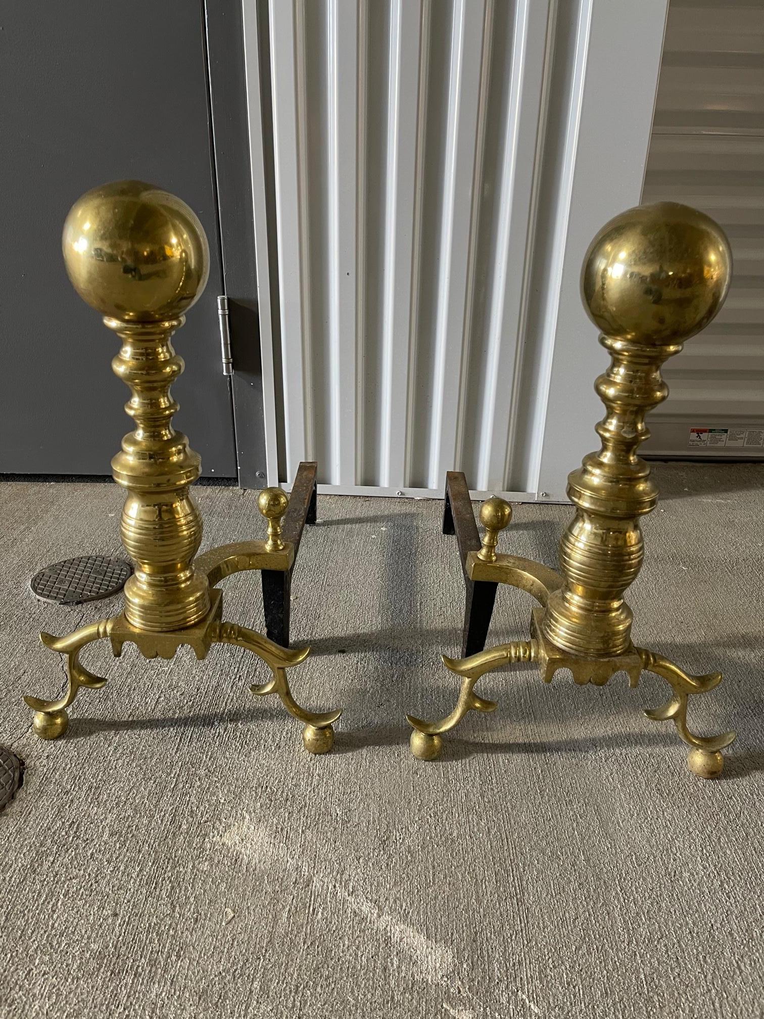 Pair of brass andirons with a decorative ball at top and feet, late 19th century.
 
