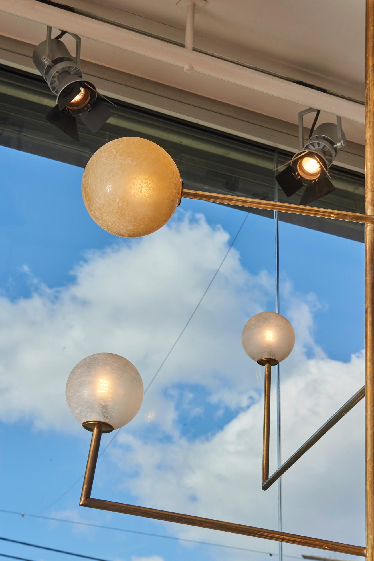 Contemporary Pair of Brass Angular Chandeliers with Glass Globes