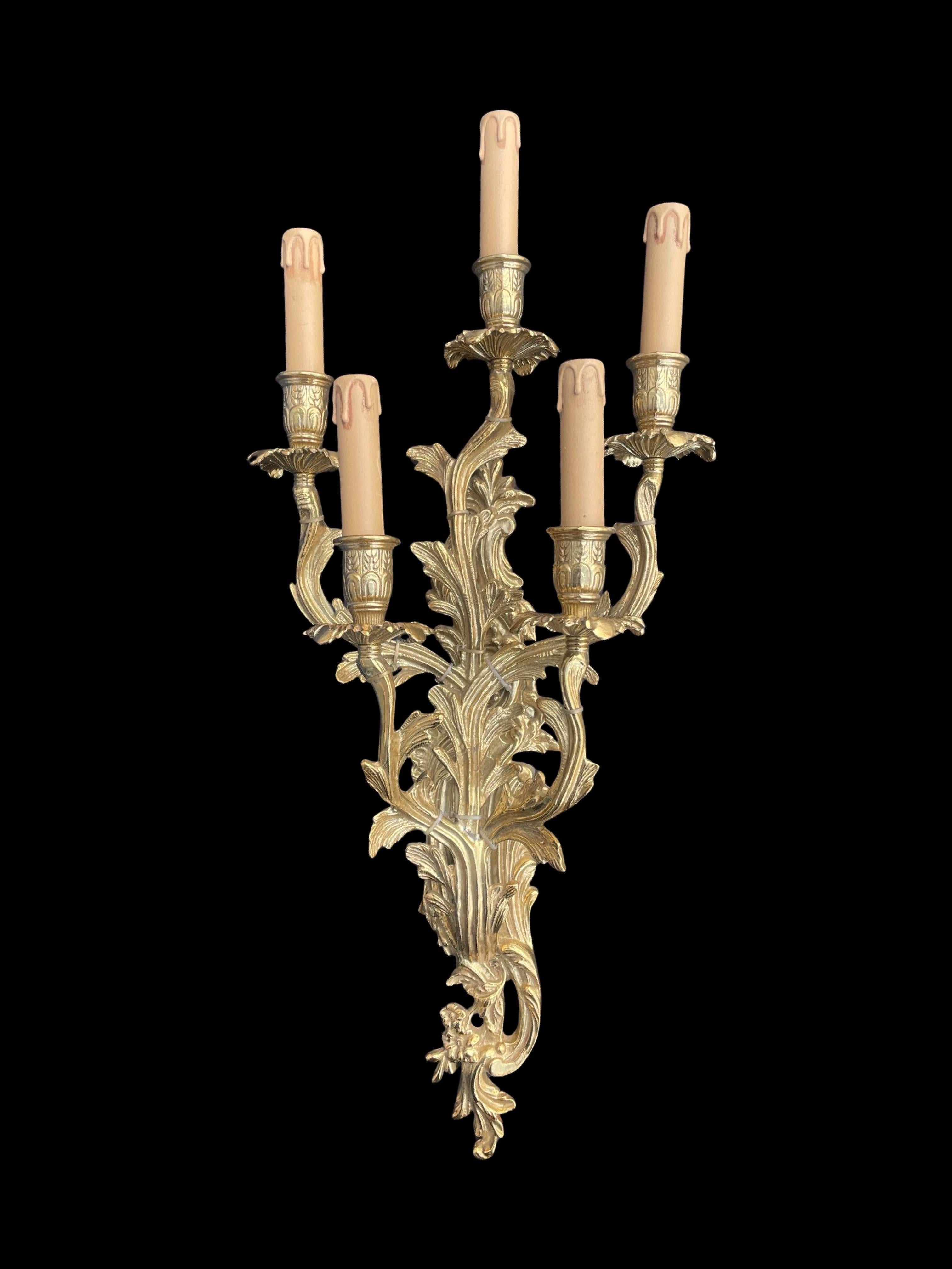 Voici une paire exquise d'appliques Badari Heritage, fabriquées en laiton massif de haute qualité pour apporter une touche d'opulence et de grandeur à n'importe quel espace. Chaque applique est dotée de cinq bras élégants, créant ainsi une présence
