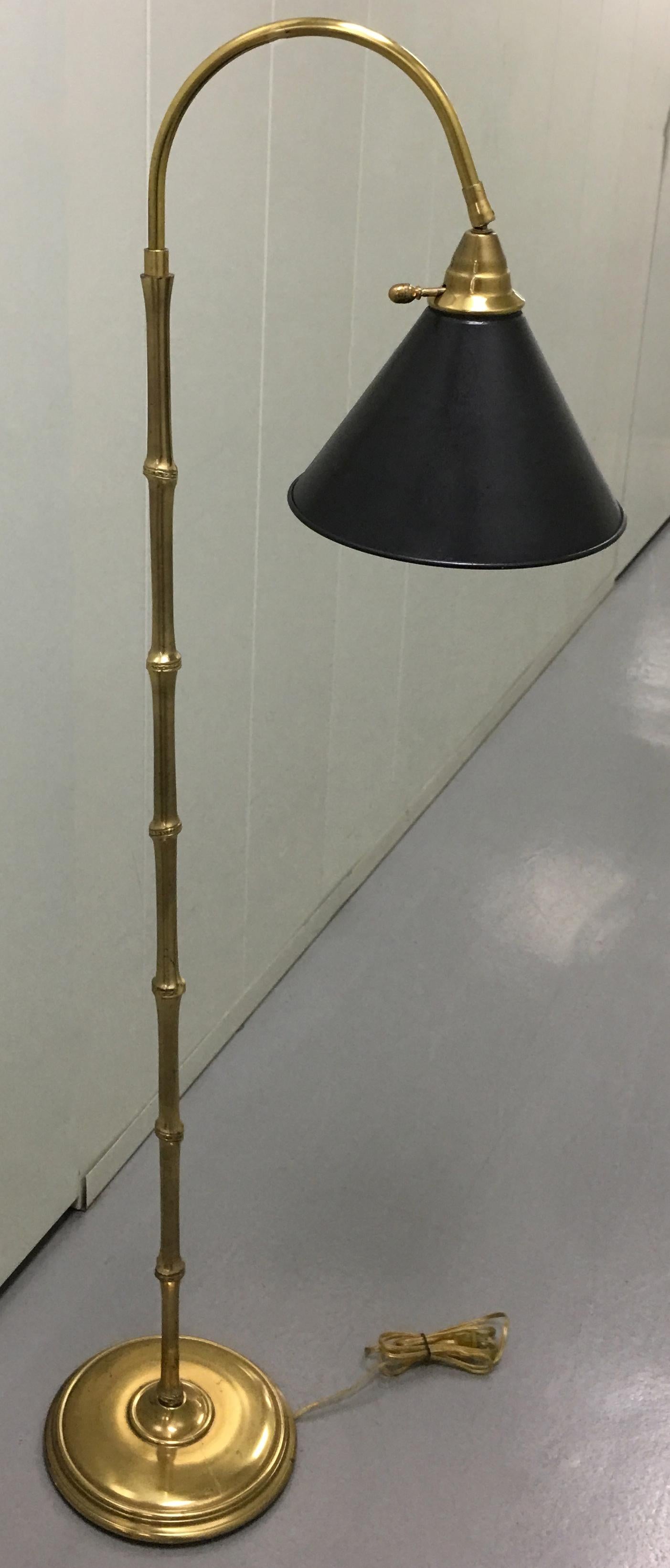 Pair of brass bamboo style floor lamps with back tole shade. Newly rewired. Each lamp takes one standard bulb.