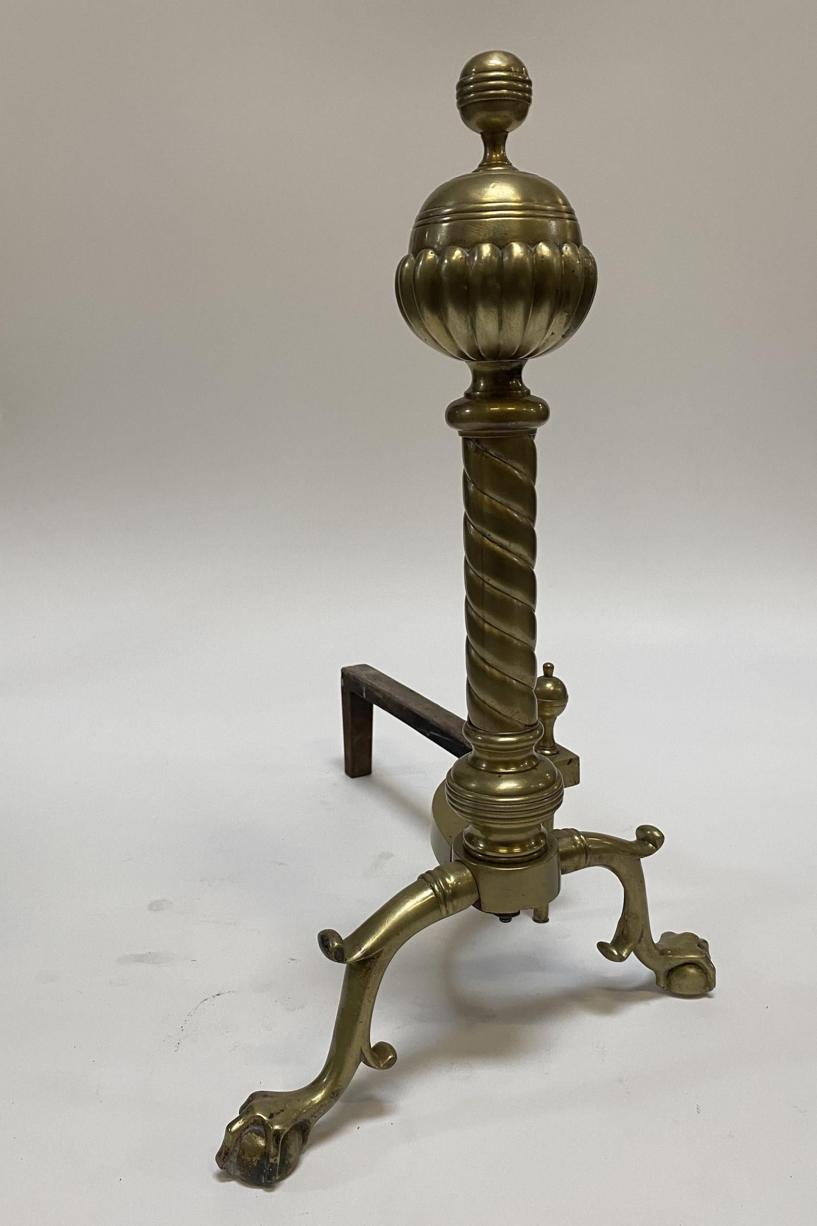 Pair of French brass belted ball-top and spiral turned clawfoot andirons with iron stands.

France, Circa 1900.