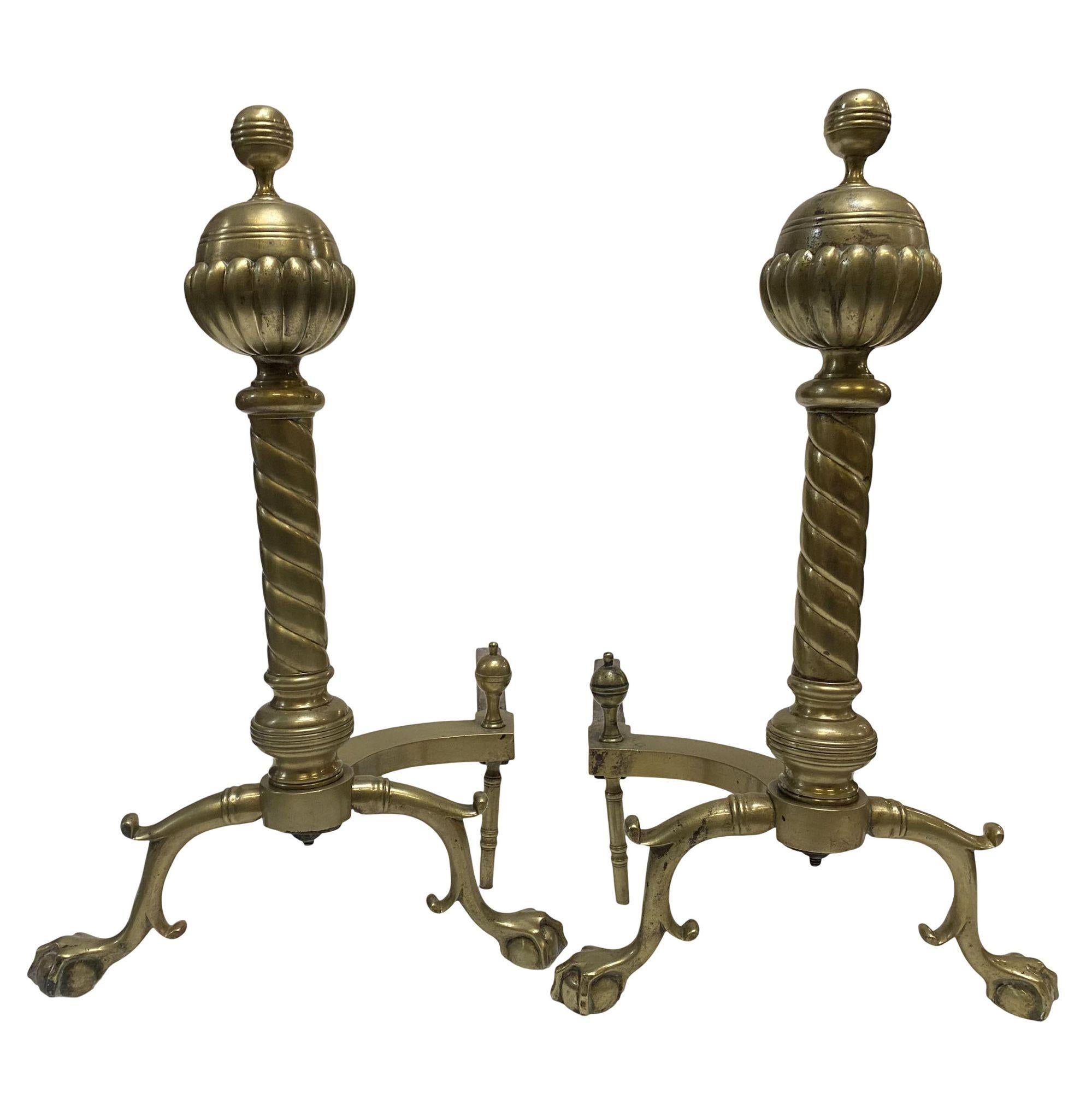 Pair of French brass belted ball-top and spiral turned clawfoot andirons with iron stands.

France, Circa 1900.