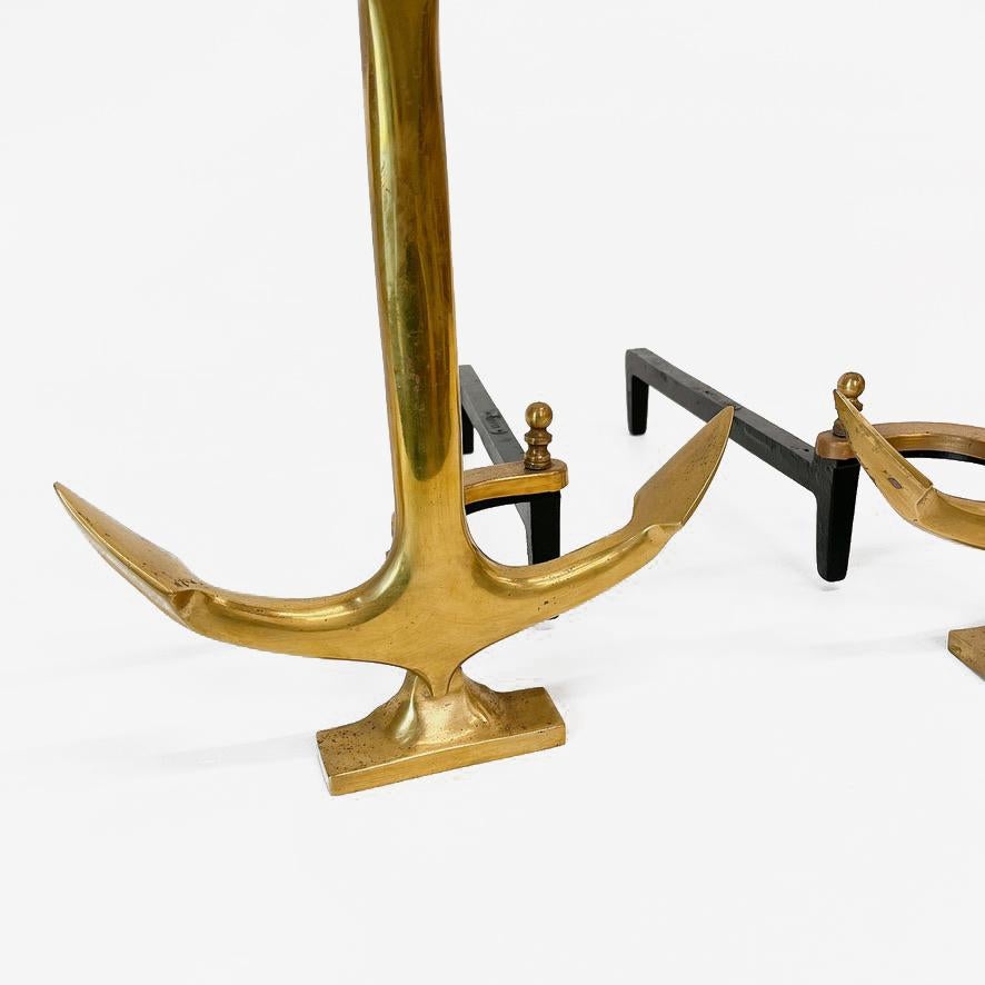 Pair of anchor-shaped andirons in polished brass with black iron stand by puritan. Made in USA, circa 1940..Perfect for beach house! 