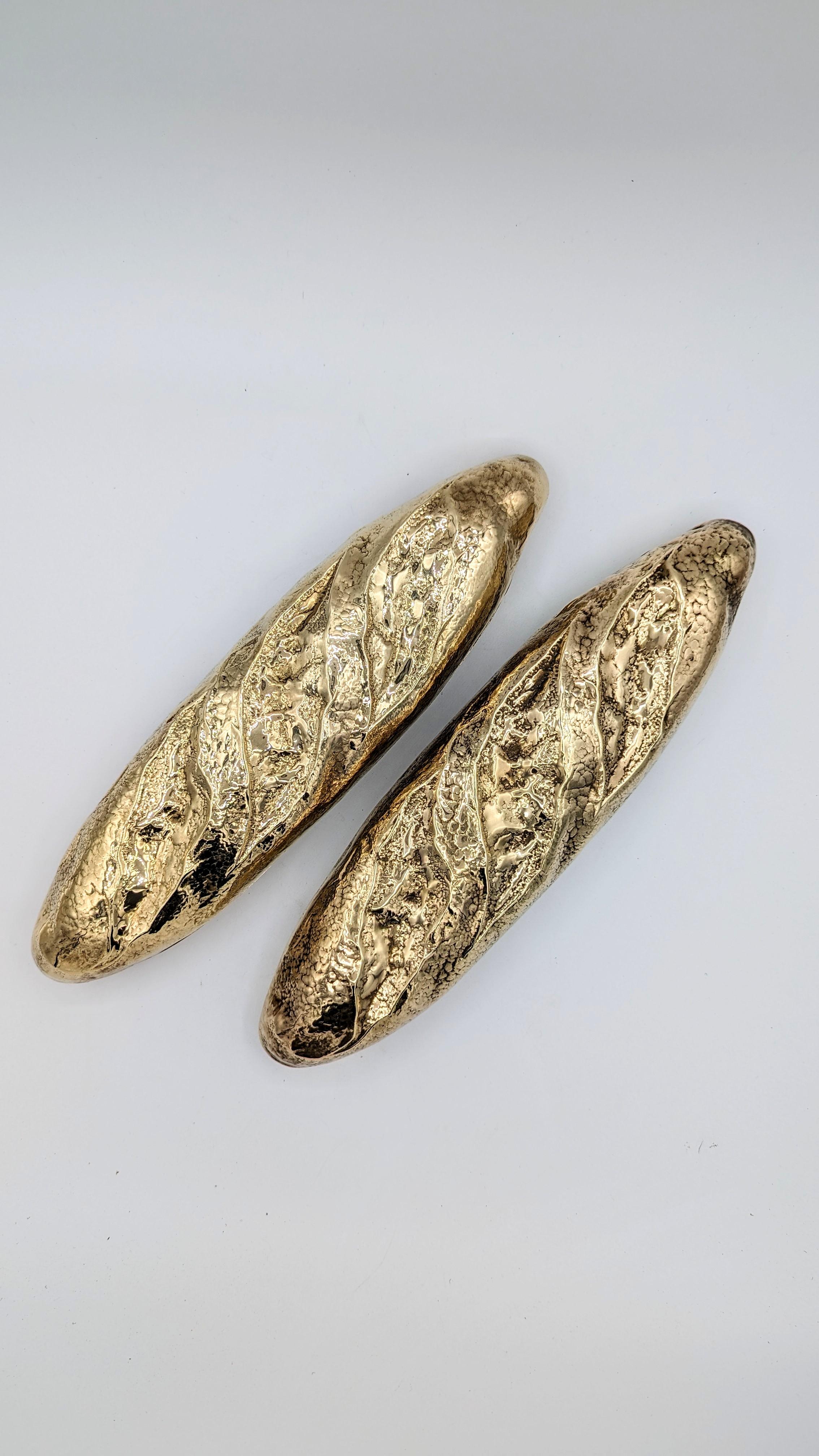 Pair of brass bread-shape boxes, signed 