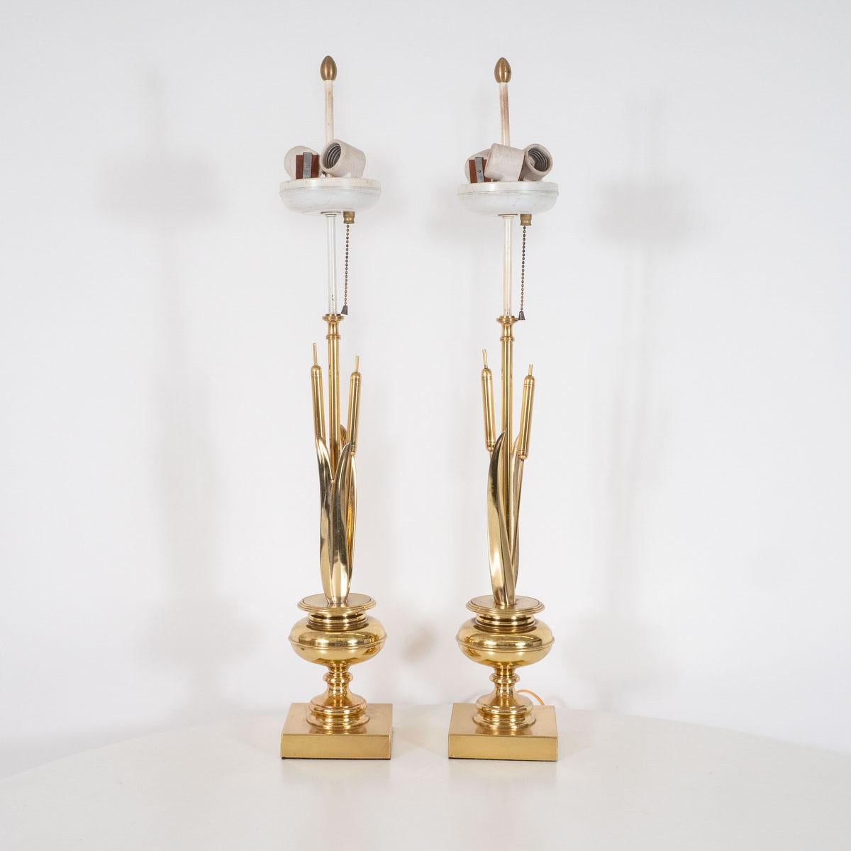 Pair of stylized brass bulrush form table lamps with urn bases.