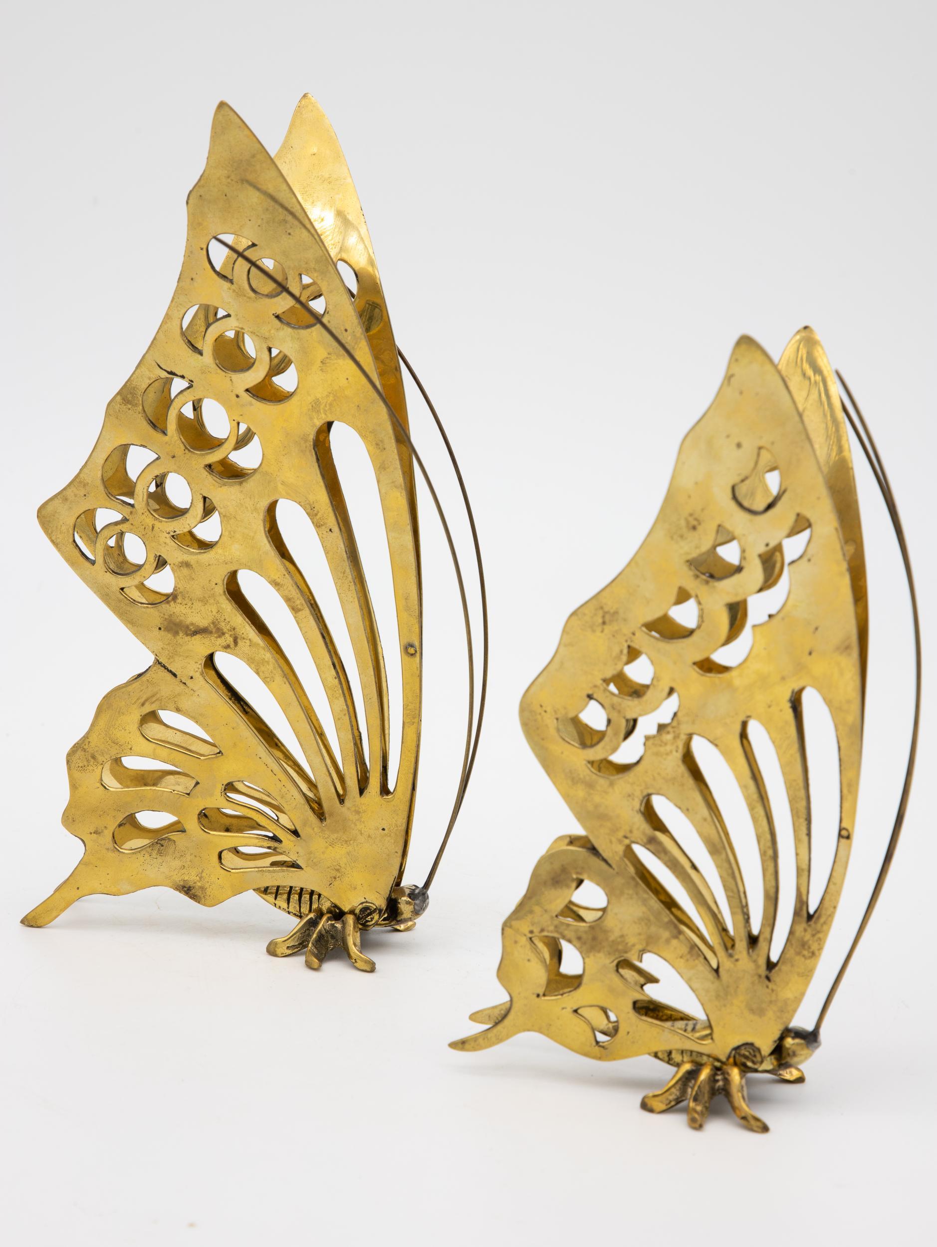 A pair of decorative brass butterflies, one slightly larger. Late 20th century. Small measures 7