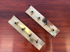 Pair of brass candelabras, model 69, by Pierre Forssell for Skultuna