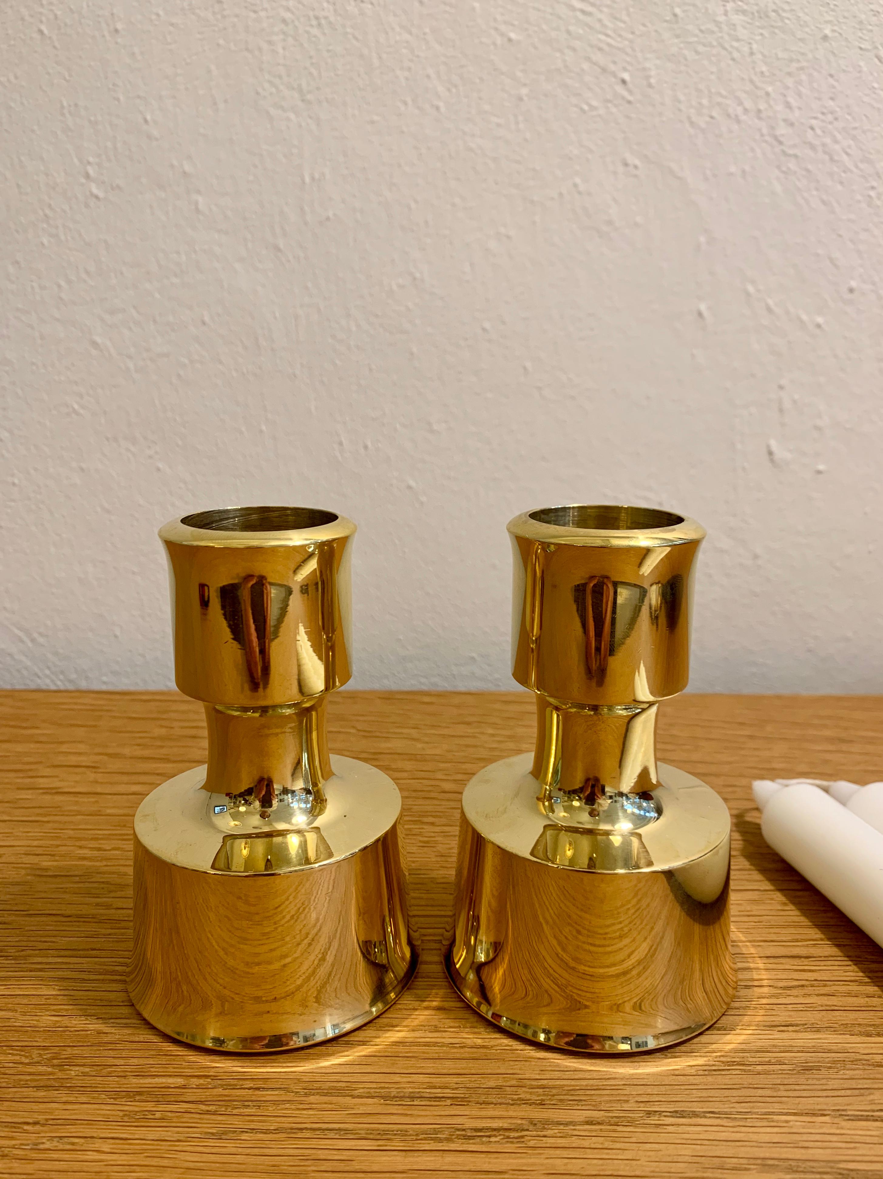 Pair of heavy solid brass candlesticks designed by Jens Harald Quistgaard in 1963 for Dansk Designs. Candle holders are polished and come in exquisite condition. 
Signed Dansk Designs Finland at interior of base (as photographed).
 