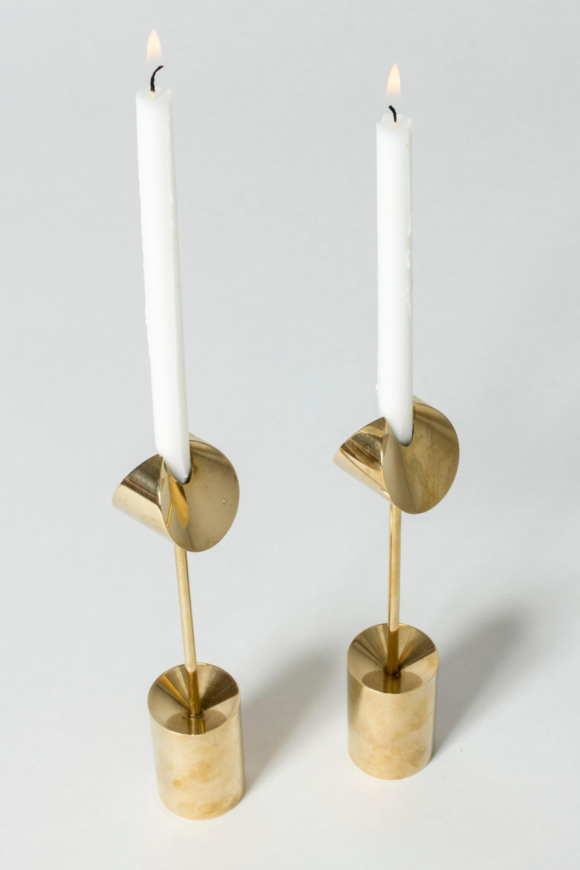 Enchanting pair of brass candlesticks by Pierre Forssell, light in their expression in a way that defies their actual heavy weight. Fit slender “Birgitta” candles, look amazing also without a candle in them.