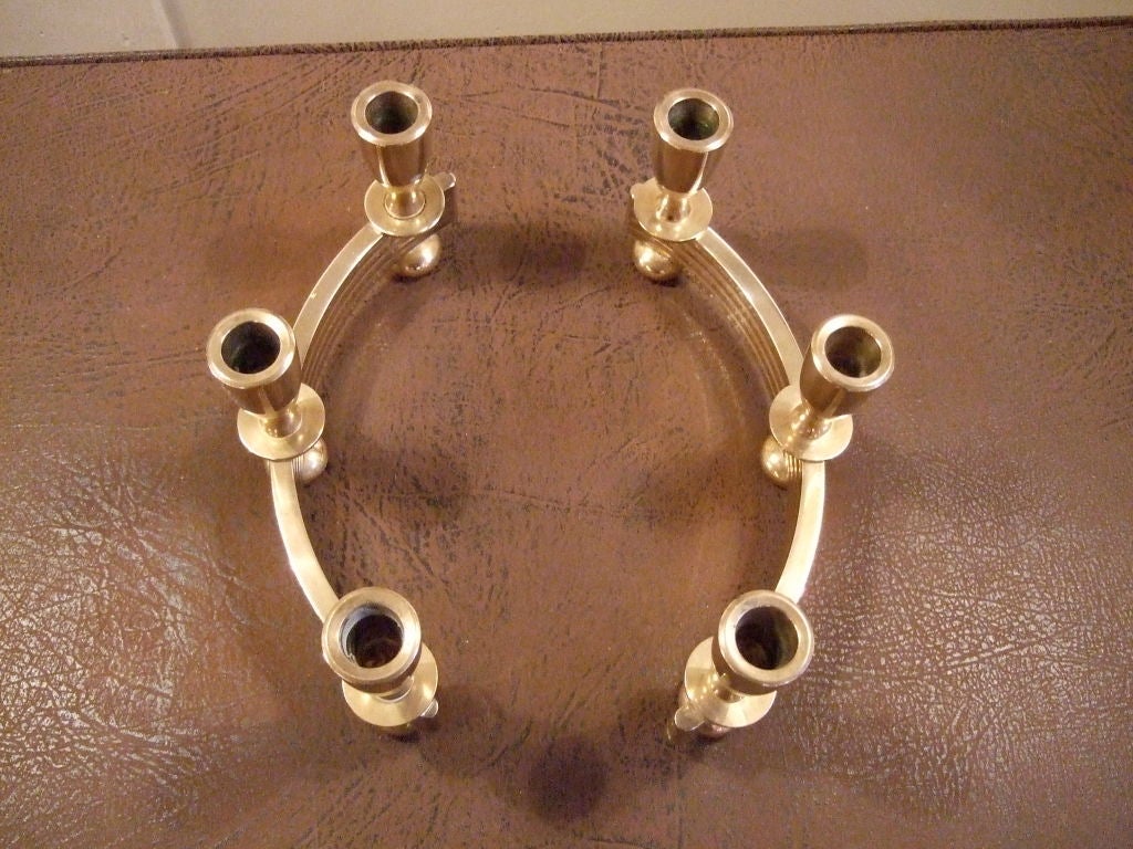 Pair of good quality, heavy, solid brass candle holders, two parts in semi circle shape combine to make an oval.