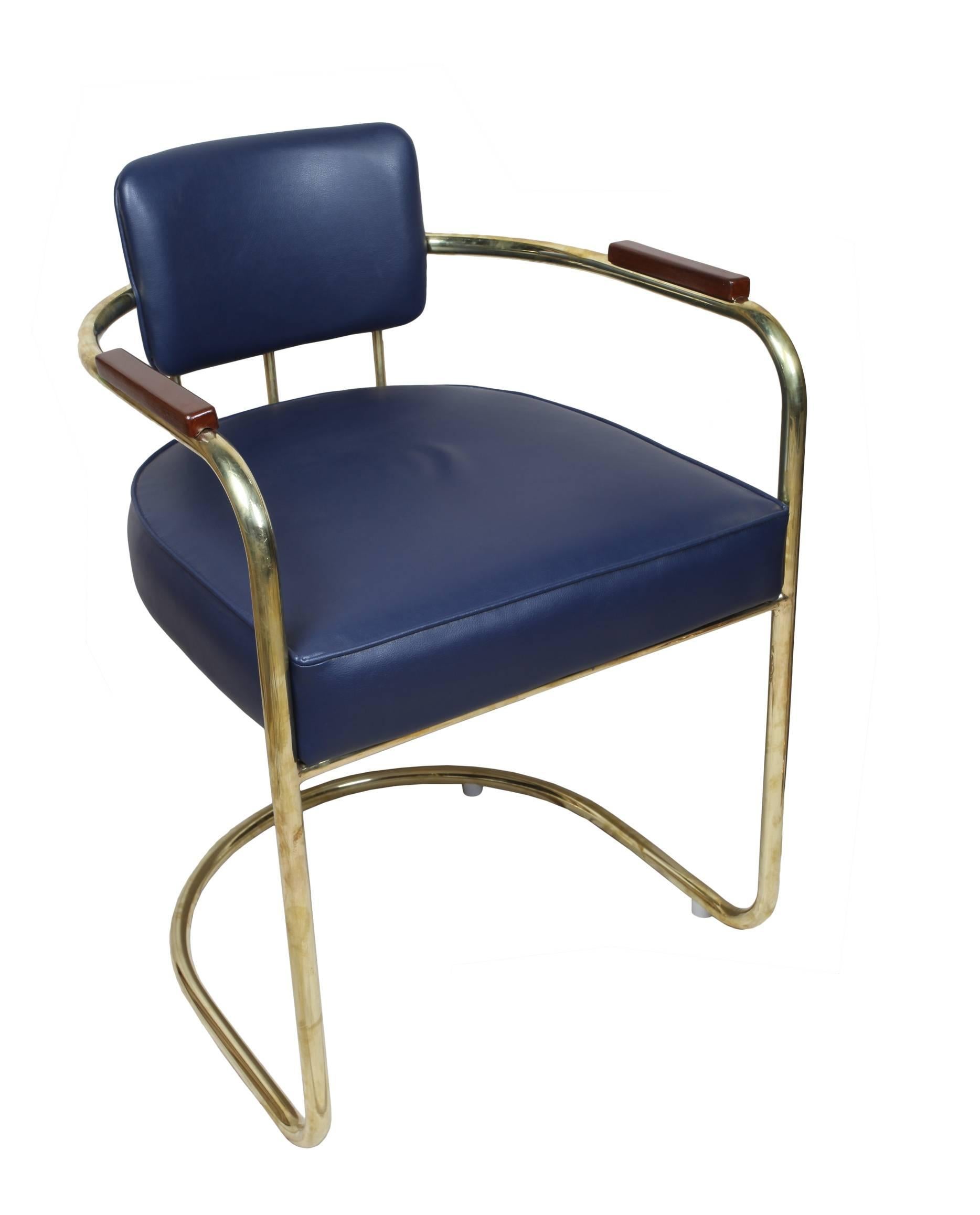 Pair of brass captain's chairs with reupholstered navy blue cushions, late 1900s. Upholstery redone. Sits slightly higher. If wanted, I can add a pair of custom-made stools with the same fabric, or a brass foot rail that sits up against a
