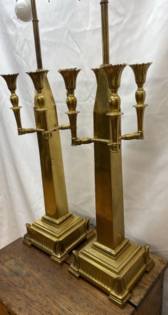 Pair of brass cathedral-style lamps with four candleholders each