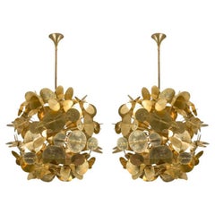 Pair of brass chandeliers by Studio Glustin