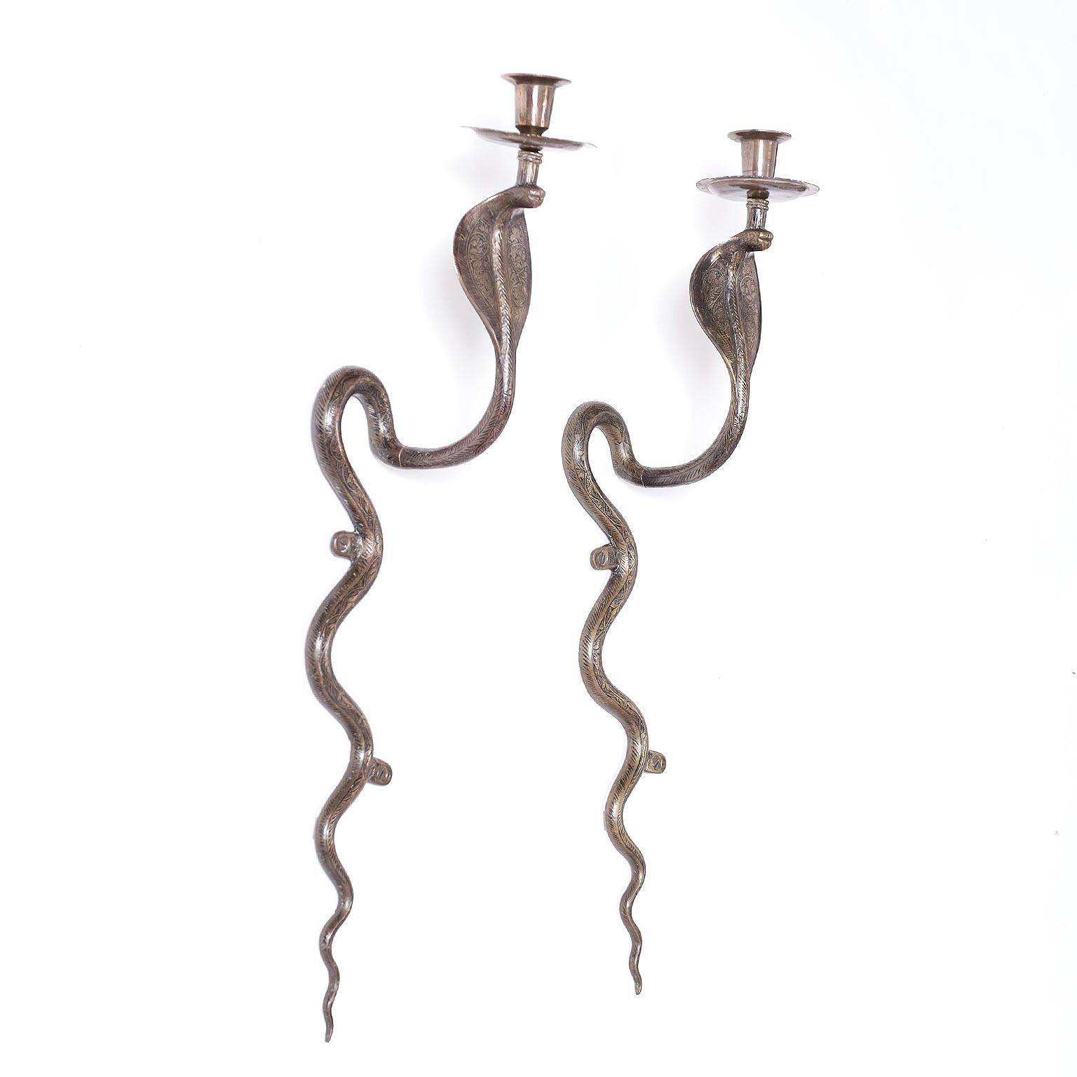 Pair of Anglo Indian wall sconces crafted in brass in the form of a cobra and decorated with engraved floral designs.