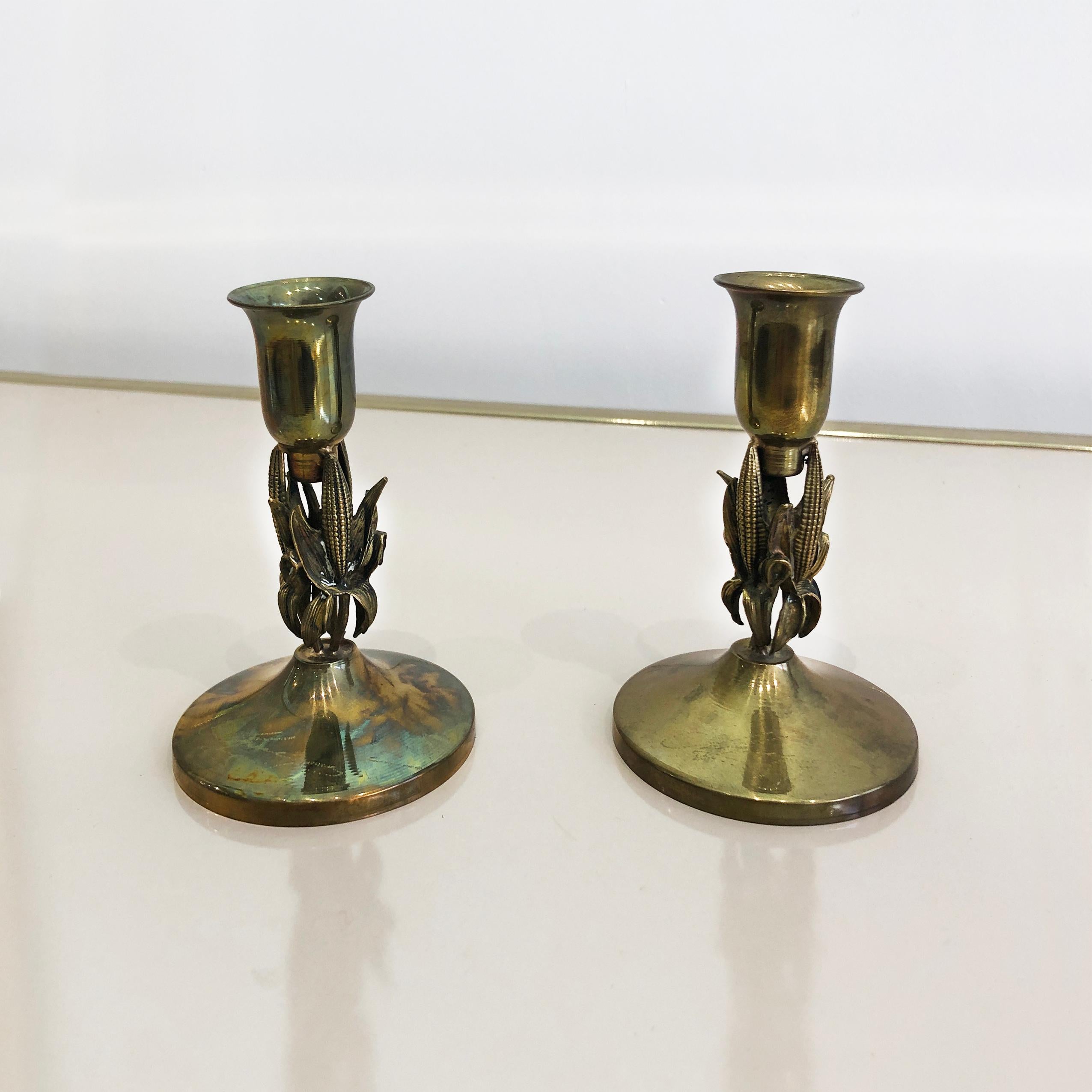 This pair of petite candlesticks, very much in the manner of Maison Charles, feature circular brass bases supporting a corn-on-the-cob midriff, finished with tulip-shaped candle holders. Indistinctly signed on the base, this pair are perfect either