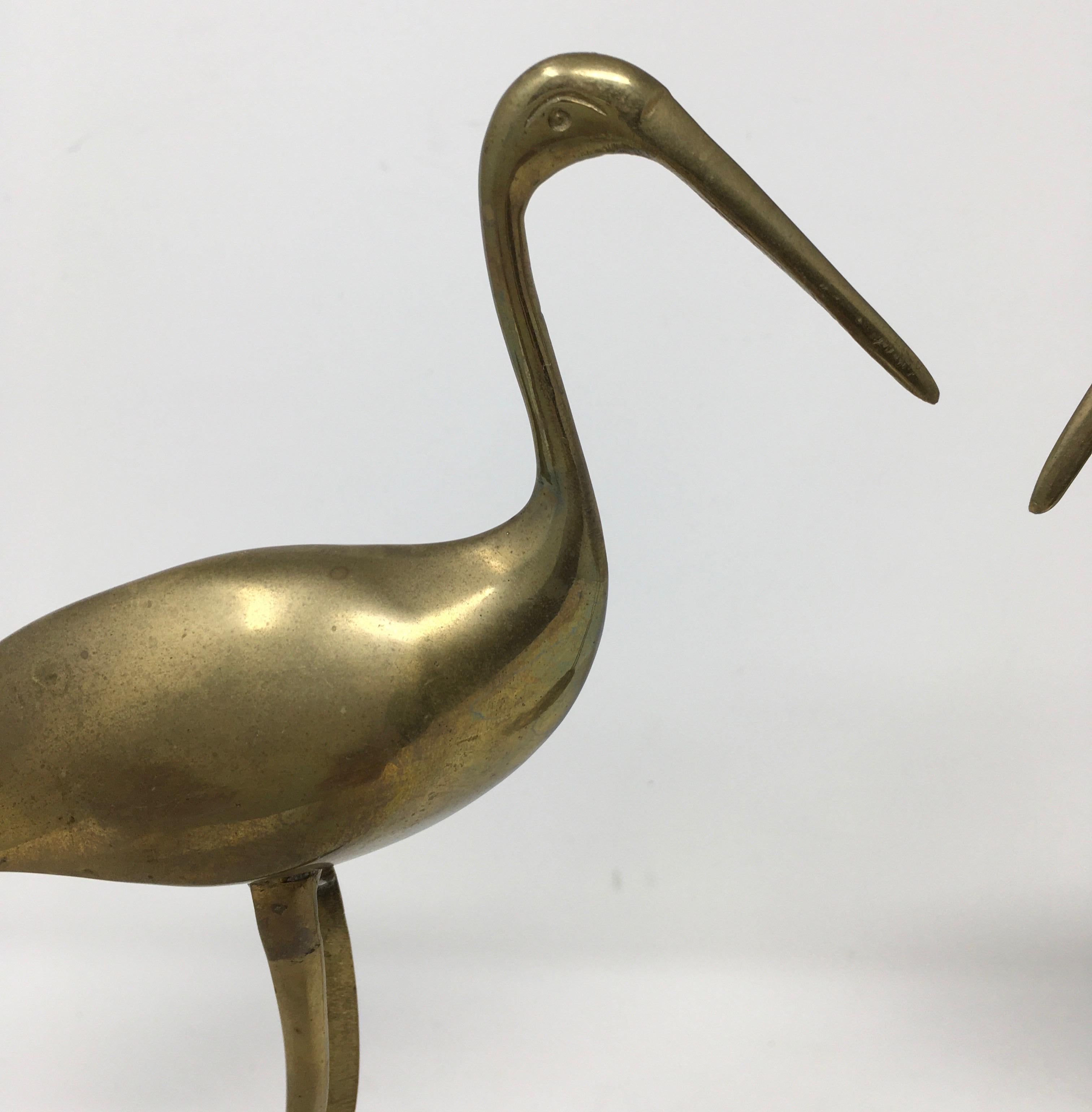 This pair of brass crane birds are very decorative, circa 1970s. Sold as a set. Measures: Larger bird: 10.5