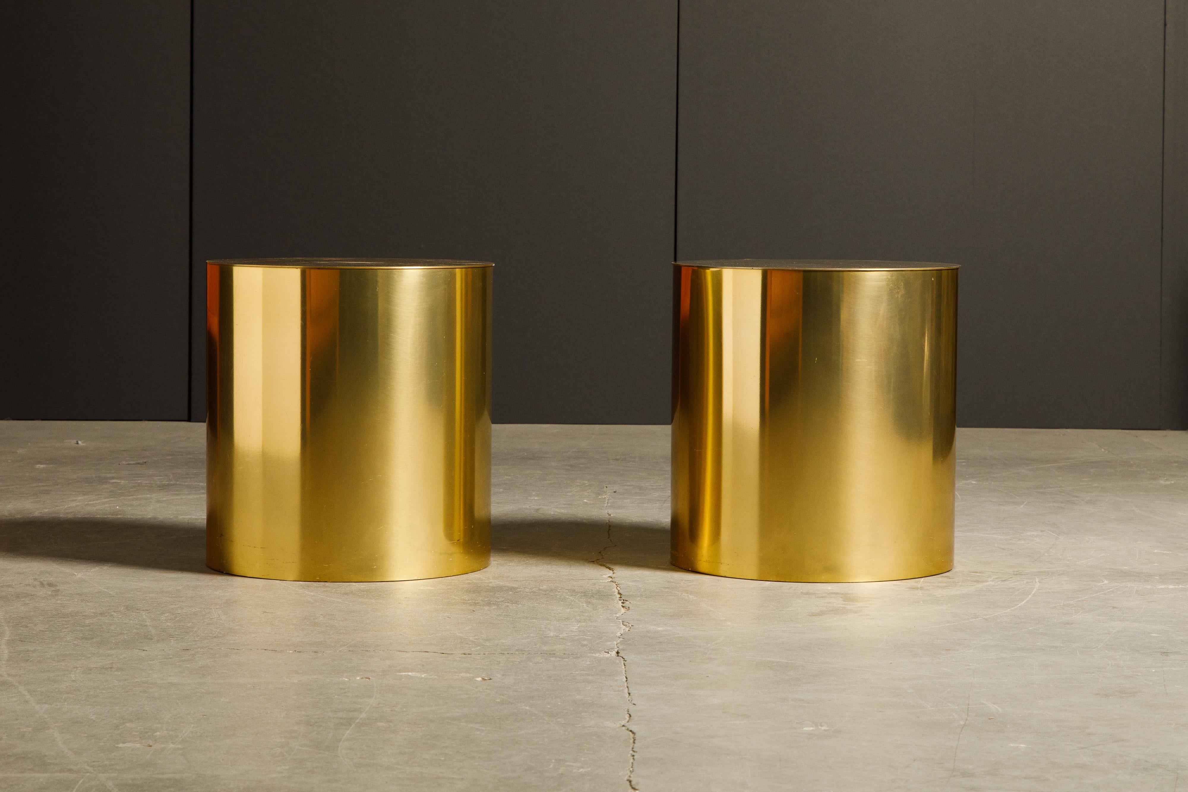 A superb pair of brass cylinder drum side tables in the style of Curtis Jere and Paul Mayen. This pair of side tables can work excellent as occasional tables to move throughout a room or used as side tables, end tables or even bedside