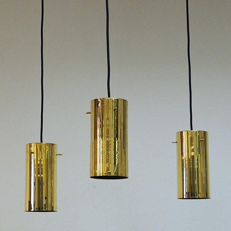 Lovely brass and cylinder-shaped ceiling lamps of model C -2899 designed by Hans-Agne Jacobsson for Markaryd Sweden in the 1960s sold as pieces.
Lovely alone or as a set of several. Looks good in the window as well. Black fabric cord. Measures: 21