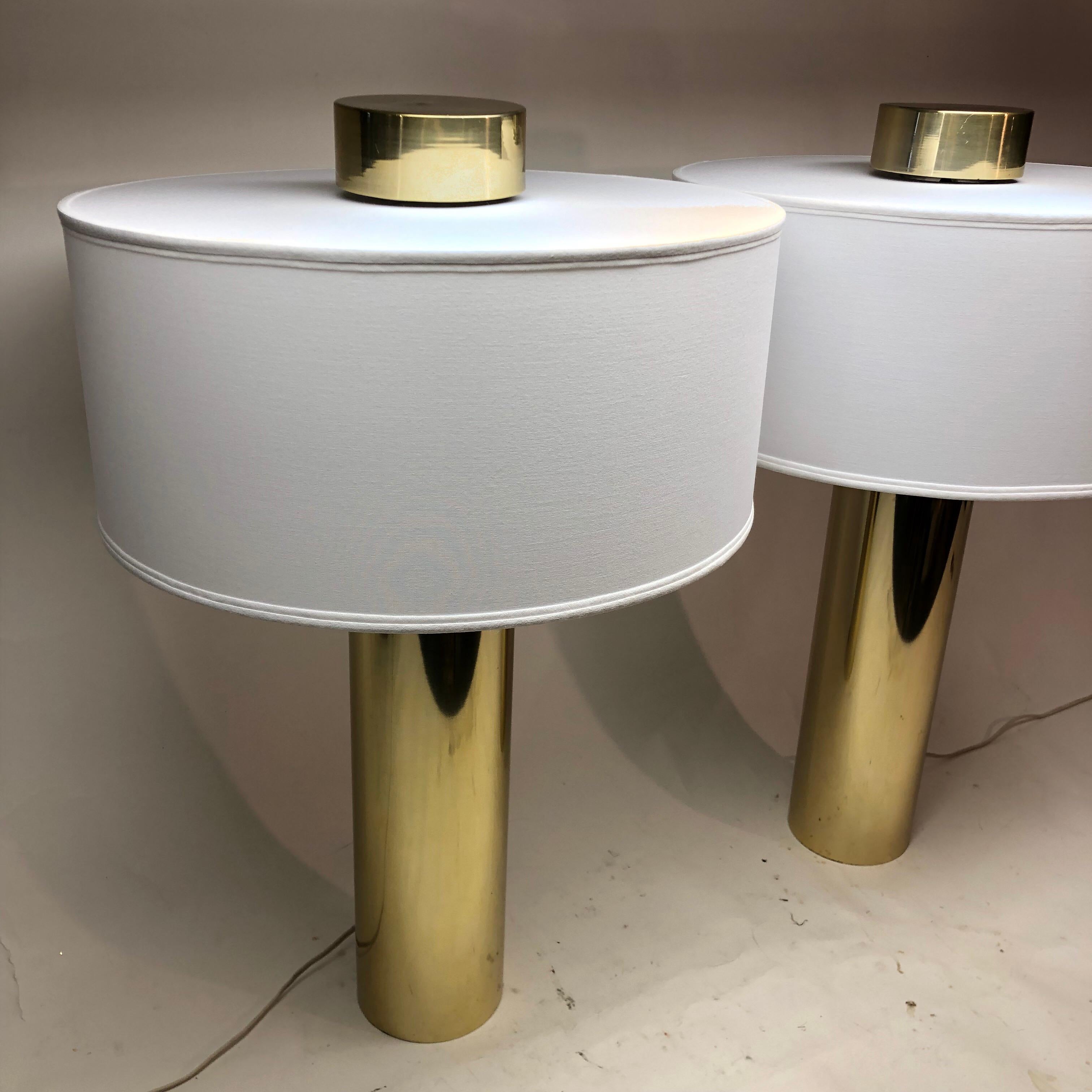 Pair of touch activated brass cylinder table lamps with custom linen lamp shades. Three way light...

Base measures 4.75