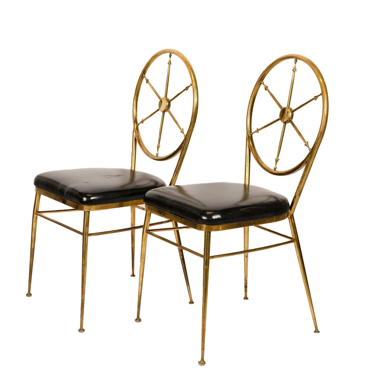 This splendid pair of brass side chairs with
captains or ships wheel backs in original black vinyl fabric ( condition noted). 
Easy to reupholster!
Attributed to Italian design icon of the mid century Gio Ponti.
I bough them from the grandson of the