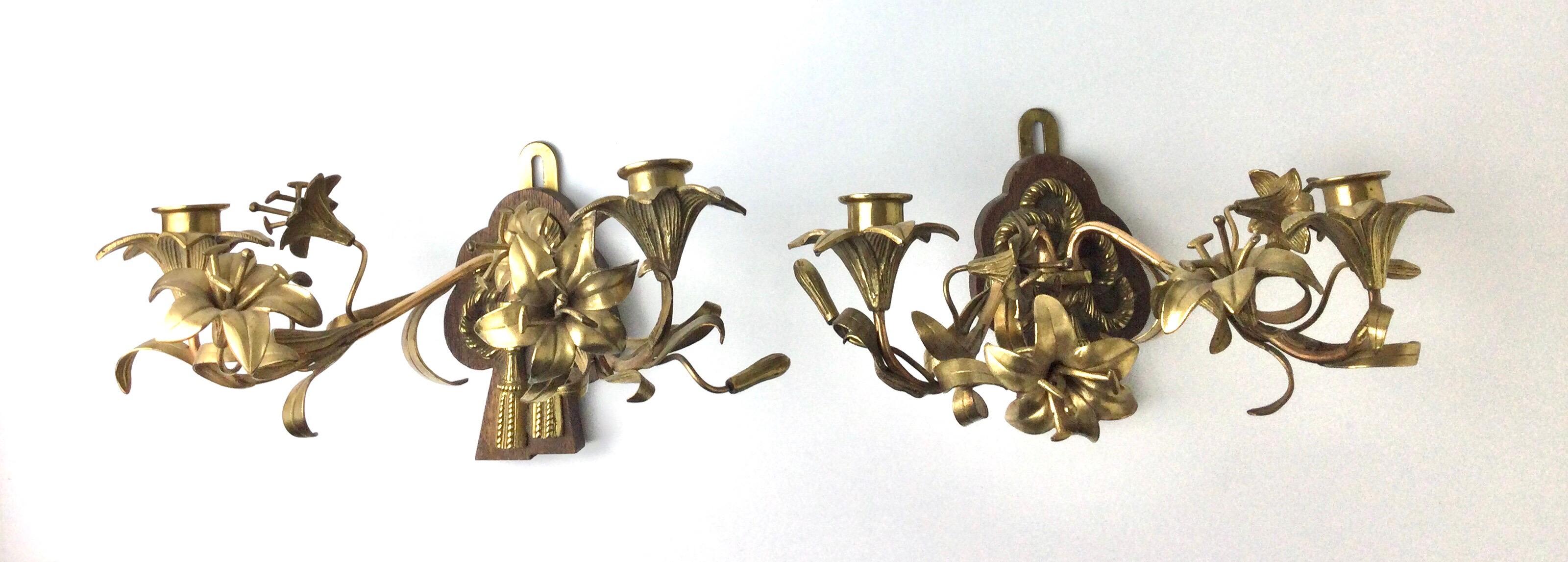 Brass arms with brass flowers mounted on wood bases. Measures: 12