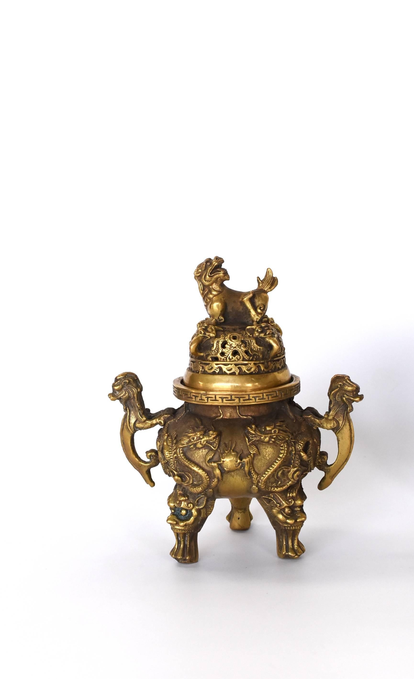 Exquisite incense burner features dragons all-over. Double dragons surrounding fire balls symbolize the vitality of life. Single dragon finial symbolizes leadership. Three mythical ox like creatures form the legs of the burner. Handles feature a