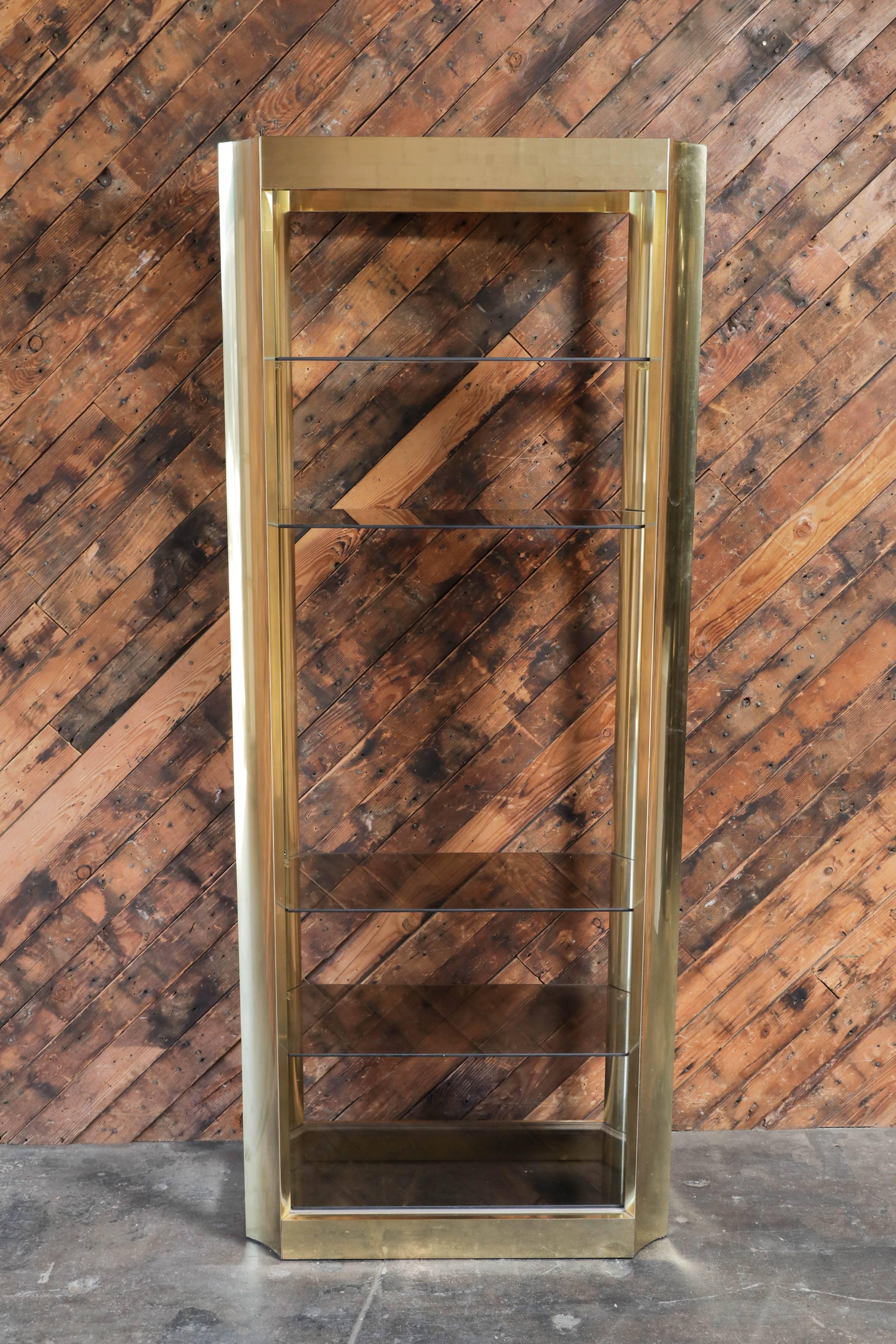 Hollywood Regency Pair of Brass Etegeres with Smoked Glass Shelves and Beautiful Curved Design For Sale
