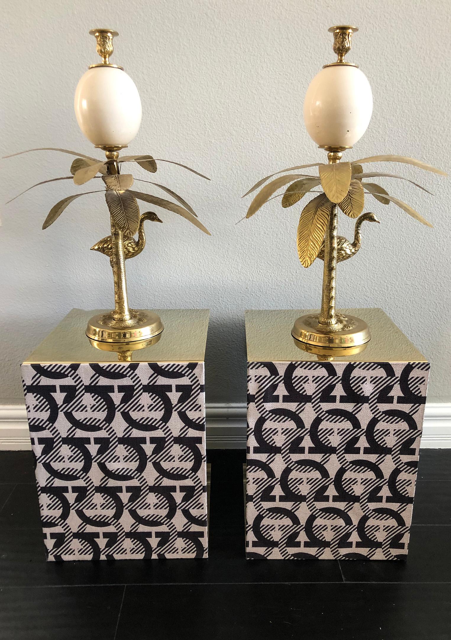 This pair of stunning Hollywood Regency style candlestick holders in brass are quite substantial and will surely be a conversation piece in any home. Cast in solid brass, these candlestick holders feature an enameled brass 