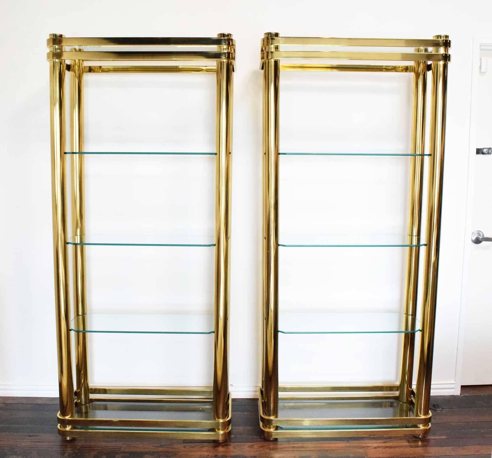 Beautiful pair of brass finish etageres, glass shelves. Heavy construction, very well made. Glass shelves are 1/2