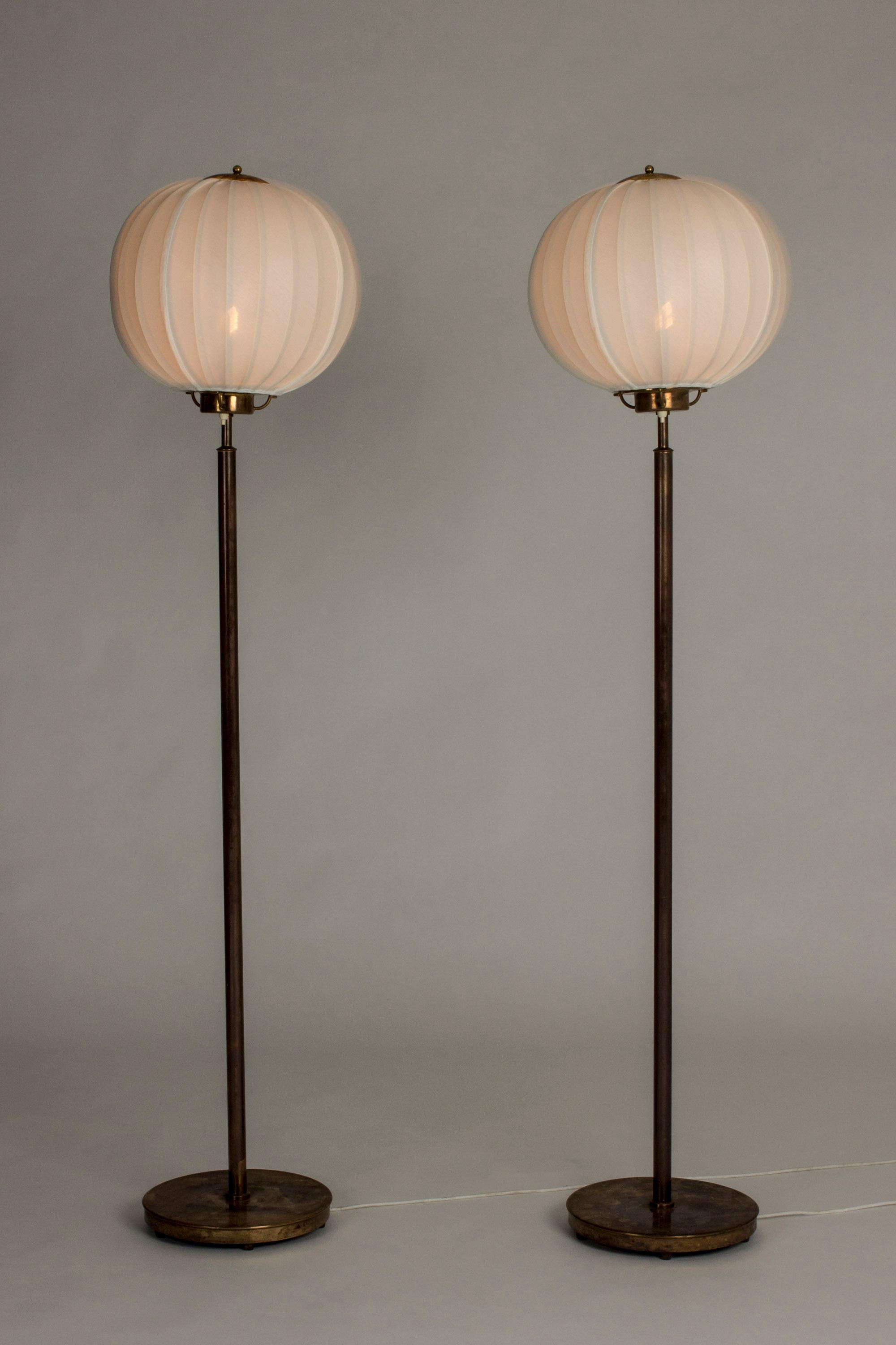 Pair of amazing floor lamps by Bertil Brisborg, made from brass. Great, dark patina. Voluminous shades that spread beautiful light. Very elegant proportions.