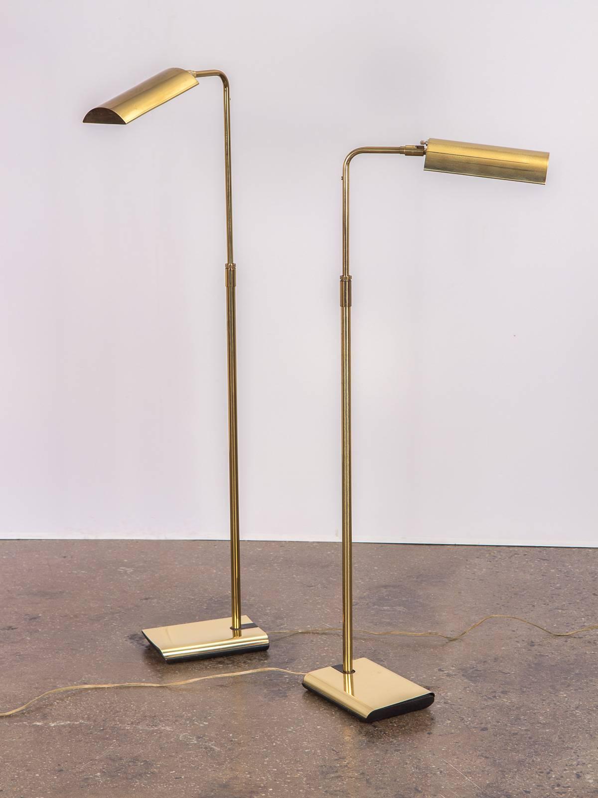 We have a pair of vintage brass floor lamps for Koch and Lowy. Fantastic reading lamp that is highly functional. Beautiful demilune shade articulates for direct lighting, and neck is adjustable for height. Tallest adjustment measures 46