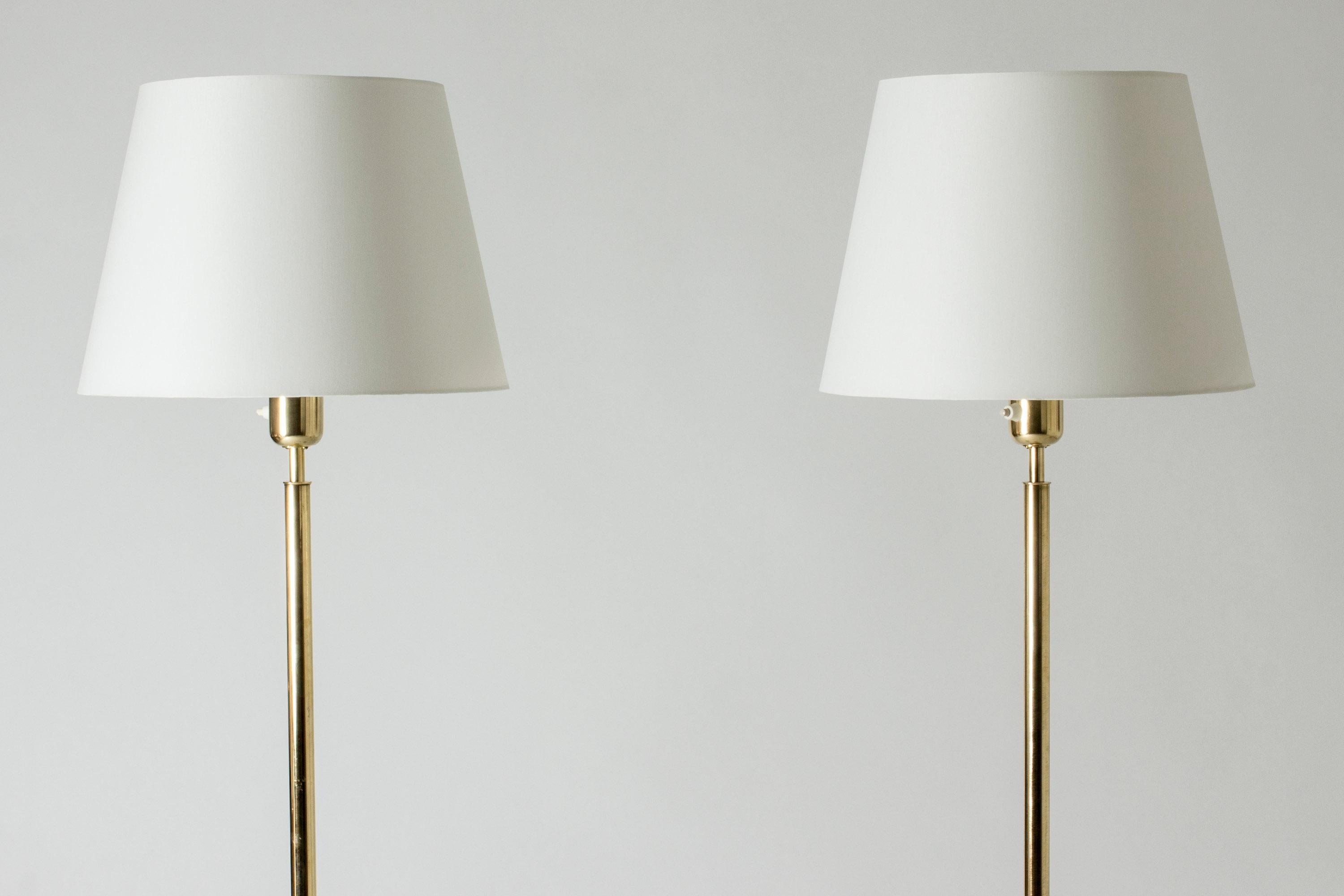 Pair of elegant floor lamps from ASEA, made from brass. Sleek lines, subtly luxurious look.