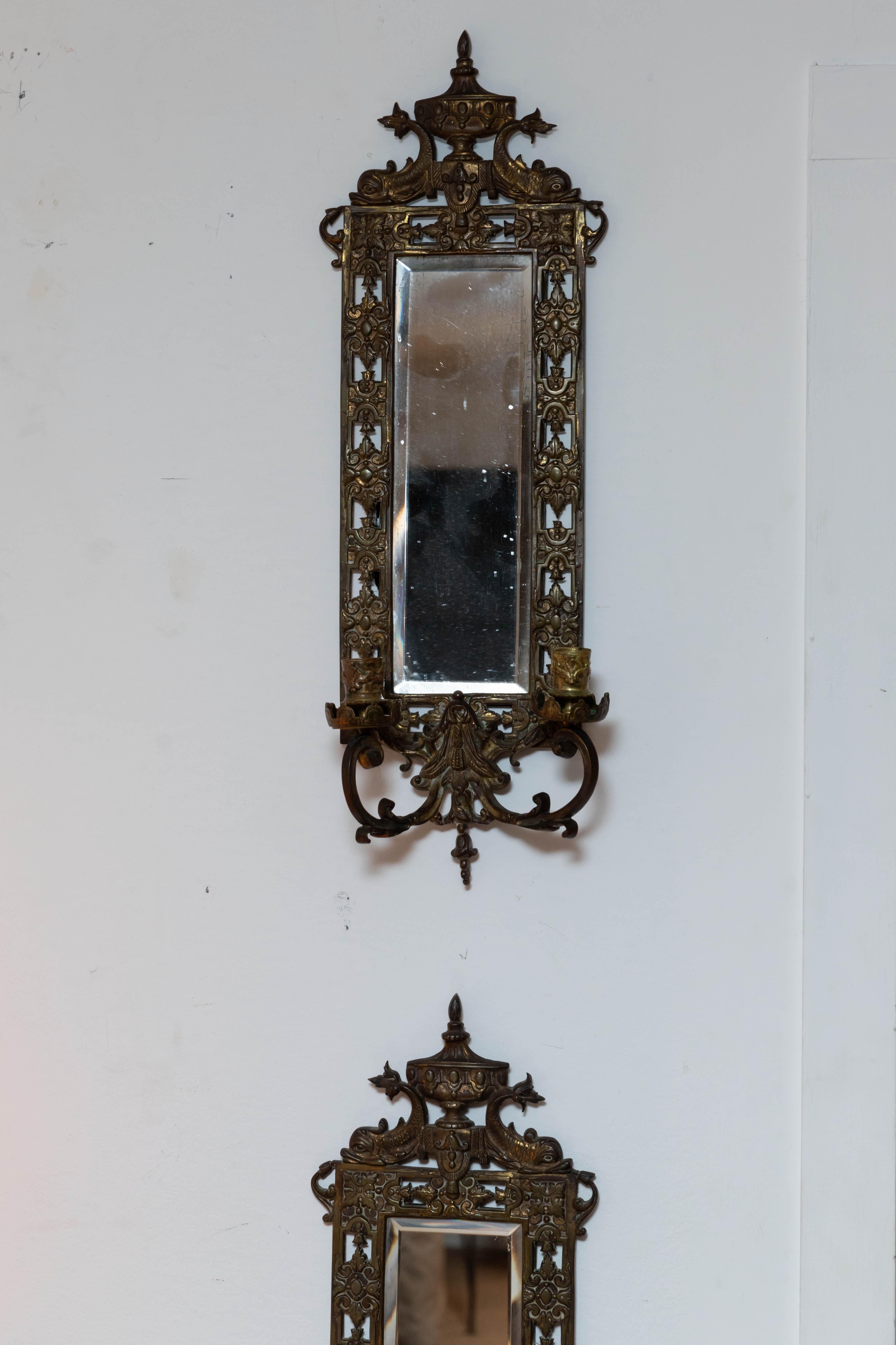 Pair of brass framed beveled mirror sconces. Original mirror.