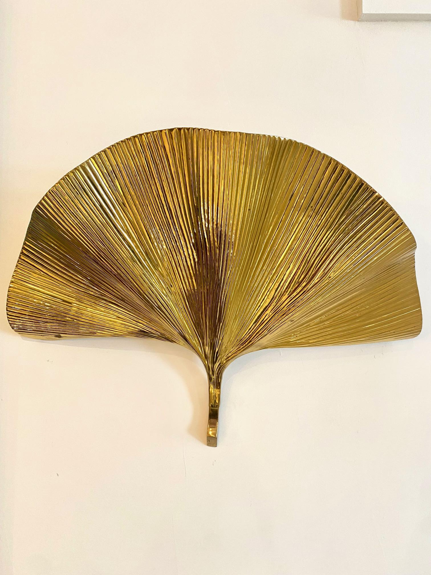 A pair of brass ginko leaf sconces by Tommaso Barbi. Label on backside 