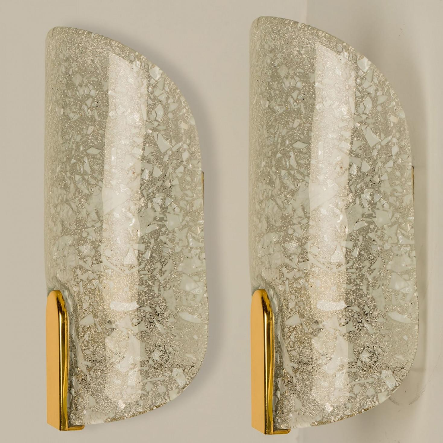 Pair of thick textured ice glass wall lights, designed in Germany around the 1960s. These messing wall lights are handcrafted and of high quality.

Illuminates beautifully. The timeless elegance of wall light is sure to lend a special atmosphere in