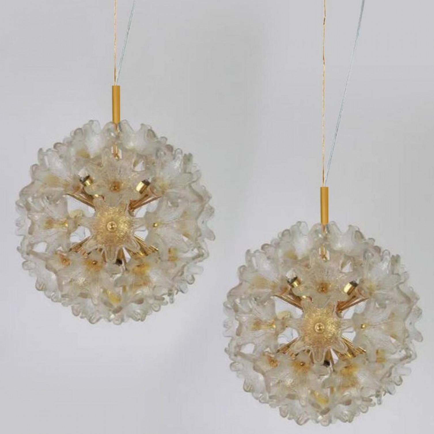 Elegant pair of Murano light fixtures by Paolo Venini for VeArt, Italy, 1960s. Brass stem and hardware and white steel fixture. Several star shaped gold or amber and clear resembles flowers. The set illuminates beautifully on wall and