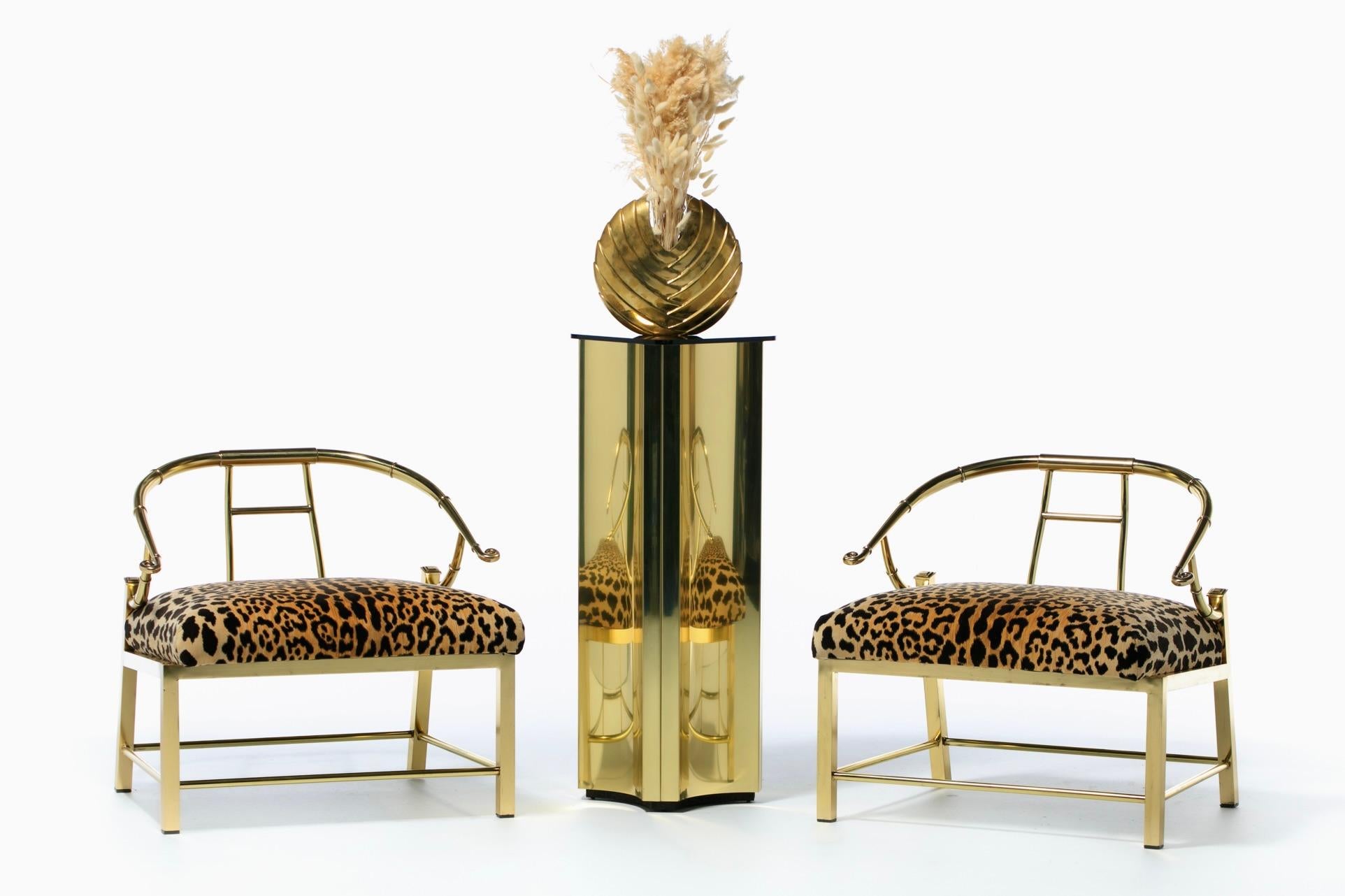 Incredibly stylish and fully restored pair of 1960s Hollywood Regency style brass chairs by Mastercraft. Elegance factor to the max and working that room with confidence. Sexy leopard velvet covers a large wide seat cushion. The cushion's extended