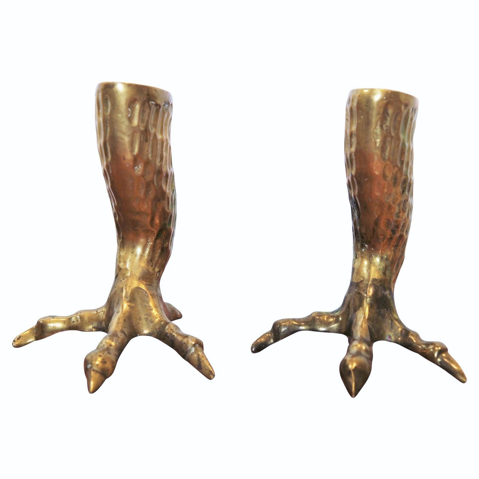 Pair of unique brass Hollywood Regency candlestick holders in the shape of eagle talons. It has very nice details of feathers and claws.