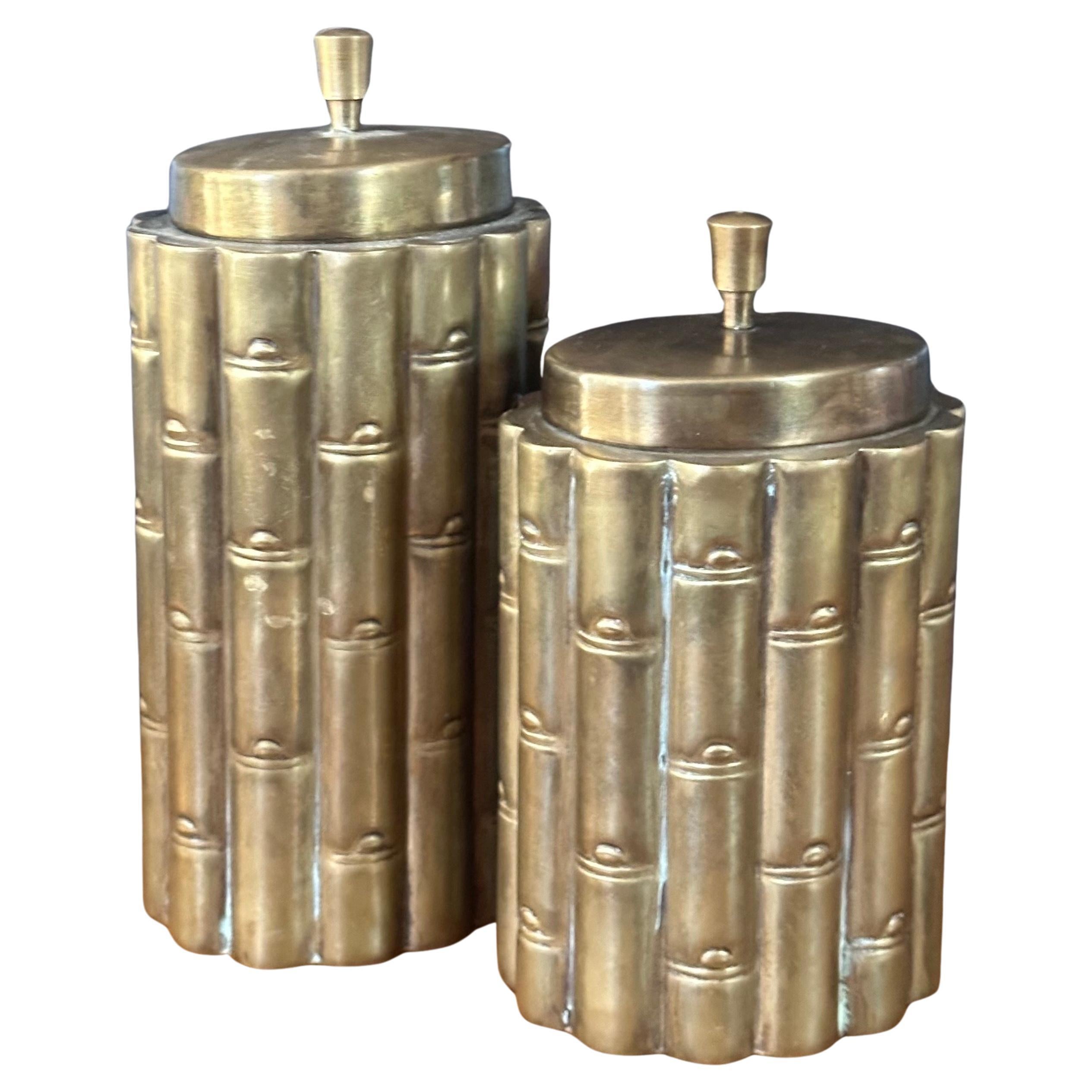A beautiful pair of brass Hollywood regency faux bamboo cannisters, circa 1970s.  The cannisters are in very good vintage condition with a great patina and measure 4.5