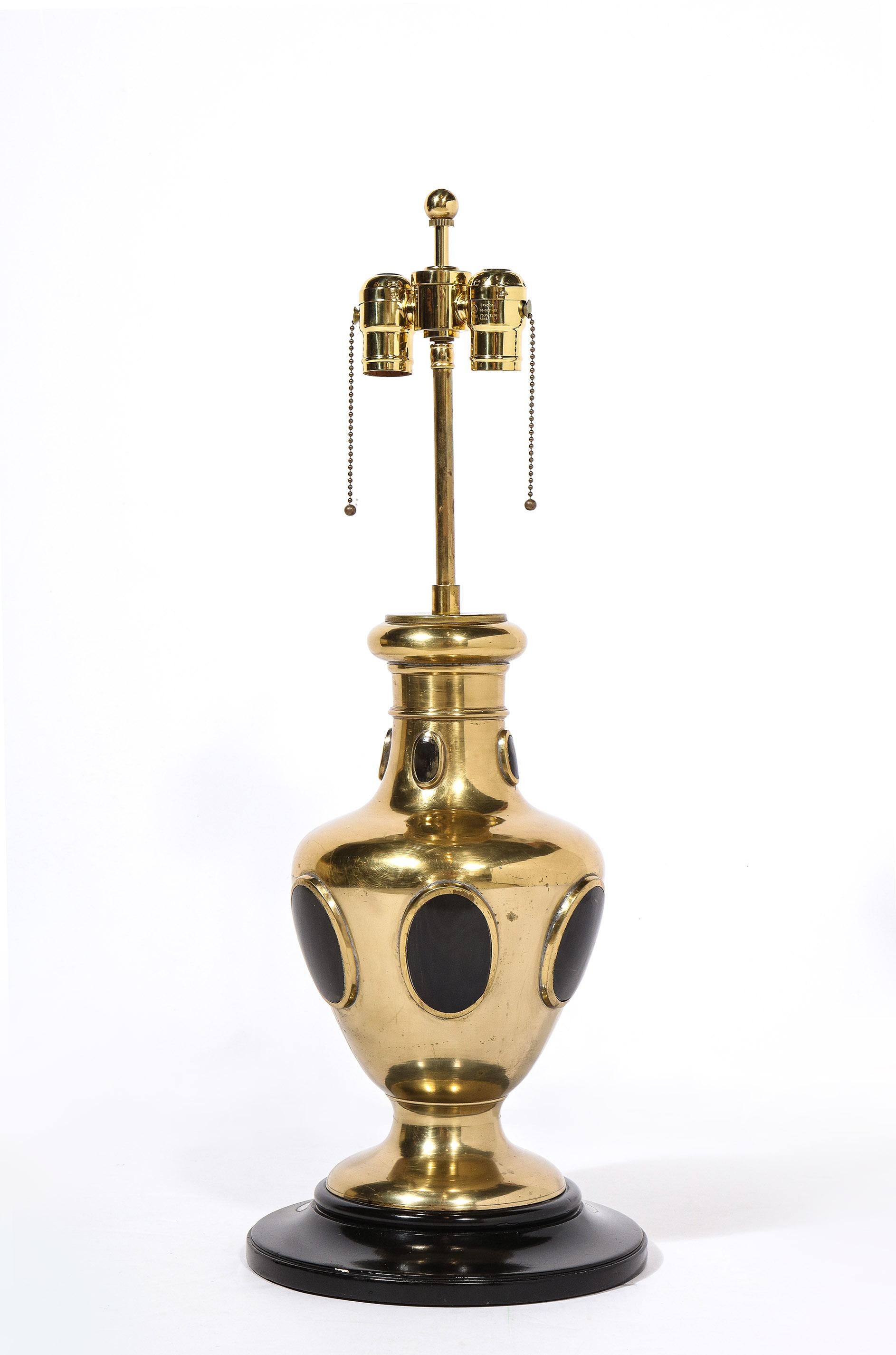 Pair of urn shaped brass table lamps with oval cabochon decoration inset with horn, set on black lacquered bases. 
Rewired with top quality fittings.