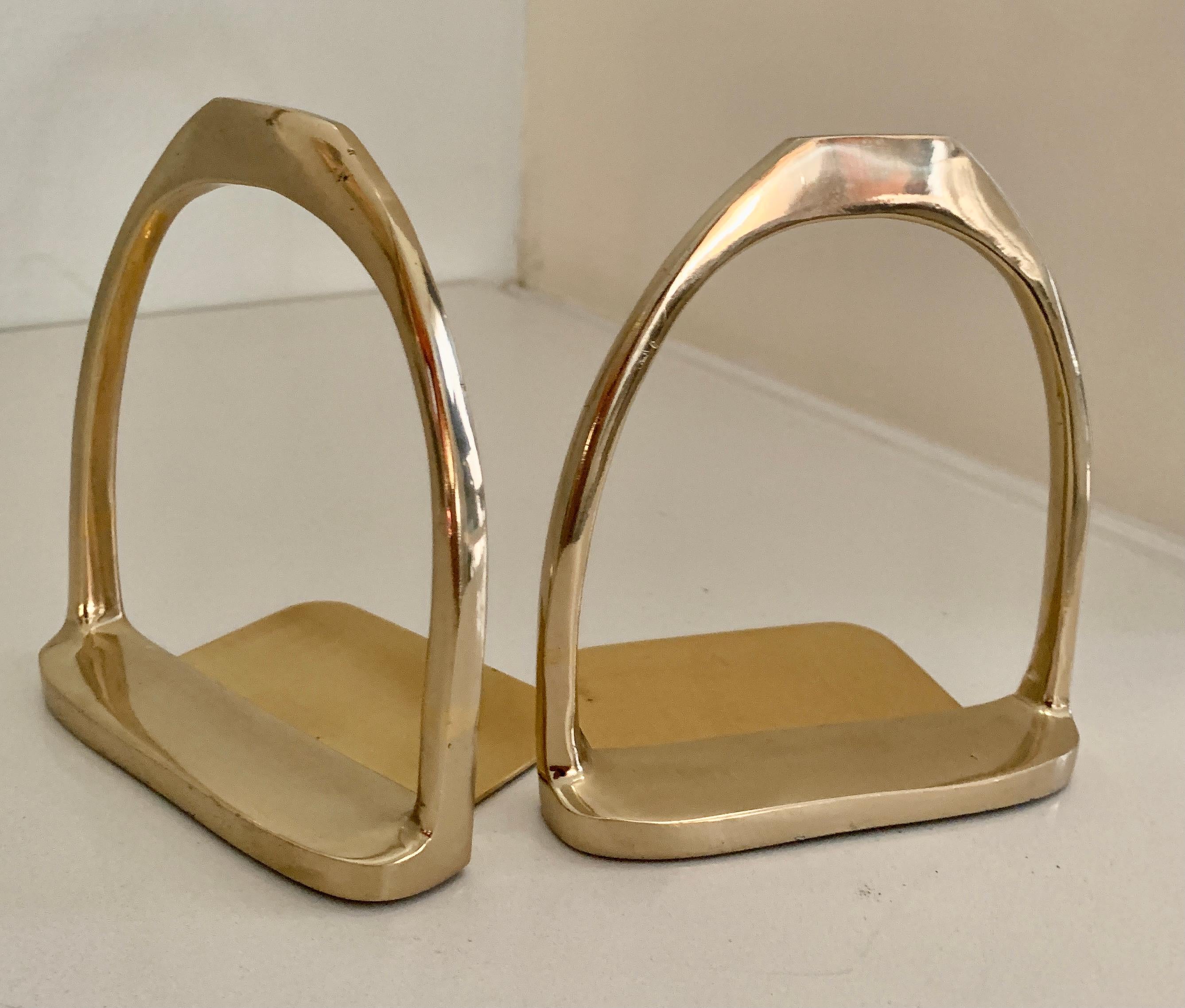 A wonderful Pair of Polished Brass Bookends in the Style of Gucci. A compliment to many interiors and especially those with an Equestrian book collection or Ralph Lauren Style Home... the pair have an extension on the underside to insure books don't