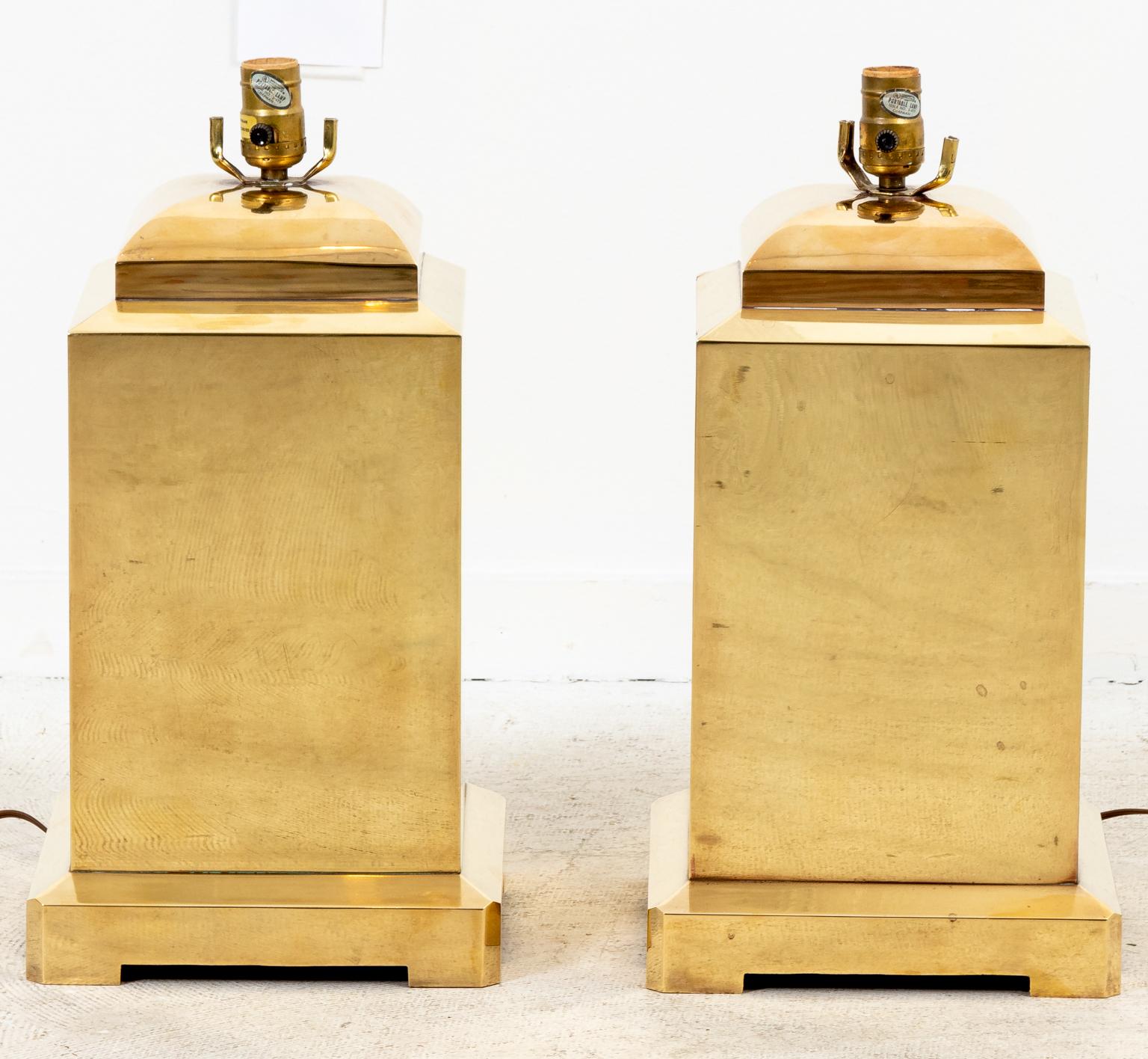 Pair of Mid-Century Modern style chapman brass lamps with label on the socket, circa 1979. Made in the United States. Please note of wear consistent with age including minor dents. Shades not included.