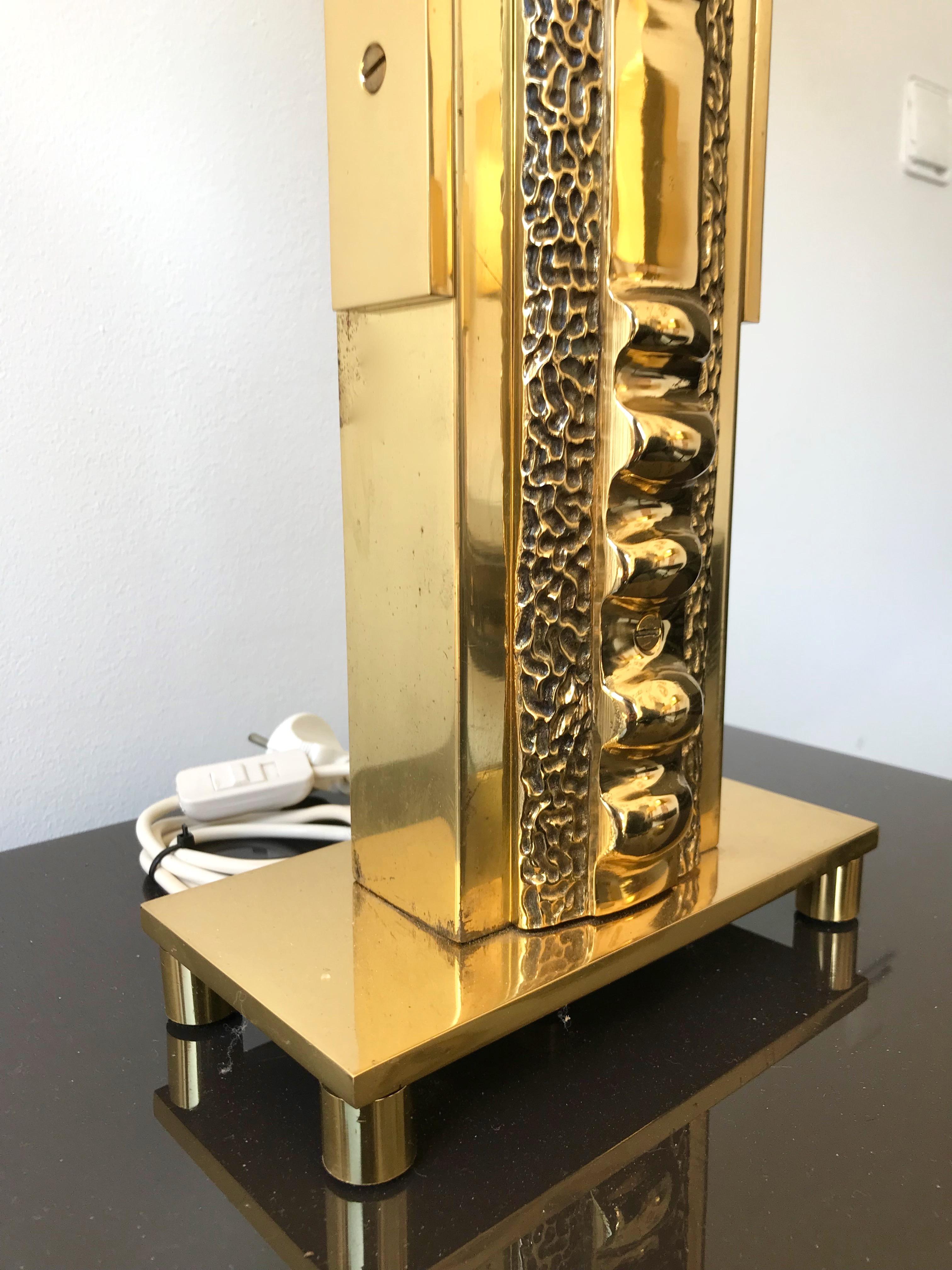Very rare pair of Brutalist sculpture totem hammered brass lamps by Luciano Frigerio. End of 1970s beginning of 1980s. Important size, very heavy, the great Frigerio work. Sign under the base. Measures: Height body lamps 64cms. Famous design like